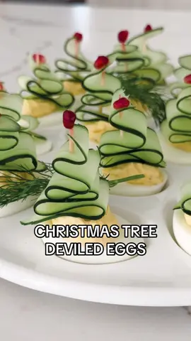 Christmas Trees Deviled Eggs * 12 hard boiled eggs  * 6 tbsp of mayo  * 2 tsp dijon mustard or yellow mustard * 3 tsp pickle juice  * 1-2 pickle spears, chopped very finely  * 2 tsp Worcestershire sauce  * salt & pepper to taste  For the tree: * 2 large cucumbers  * Pomegranate seeds  * Optional: dill sprigs  Cook and peel the eggs for hard boiled. Cut in half and make the egg mixture with the yolks. Add all ingredients above, and mix well until very smooth. Pipe or spoon the filling into each egg half. With a peeler, slice a cucumber on the same direction lengthwise, trying to get thin slices. Form a tree shape as you see on the video, pass a toothpick in the middle to keep it together and add a pomegranate seed on the top. Use this as a topper for each egg. Serve them on a plate and add some dill to the platter if desired. Enjoy! #christmastree #christmasrecipe #deviledeggs #easyappetizers #holidayappetizer 