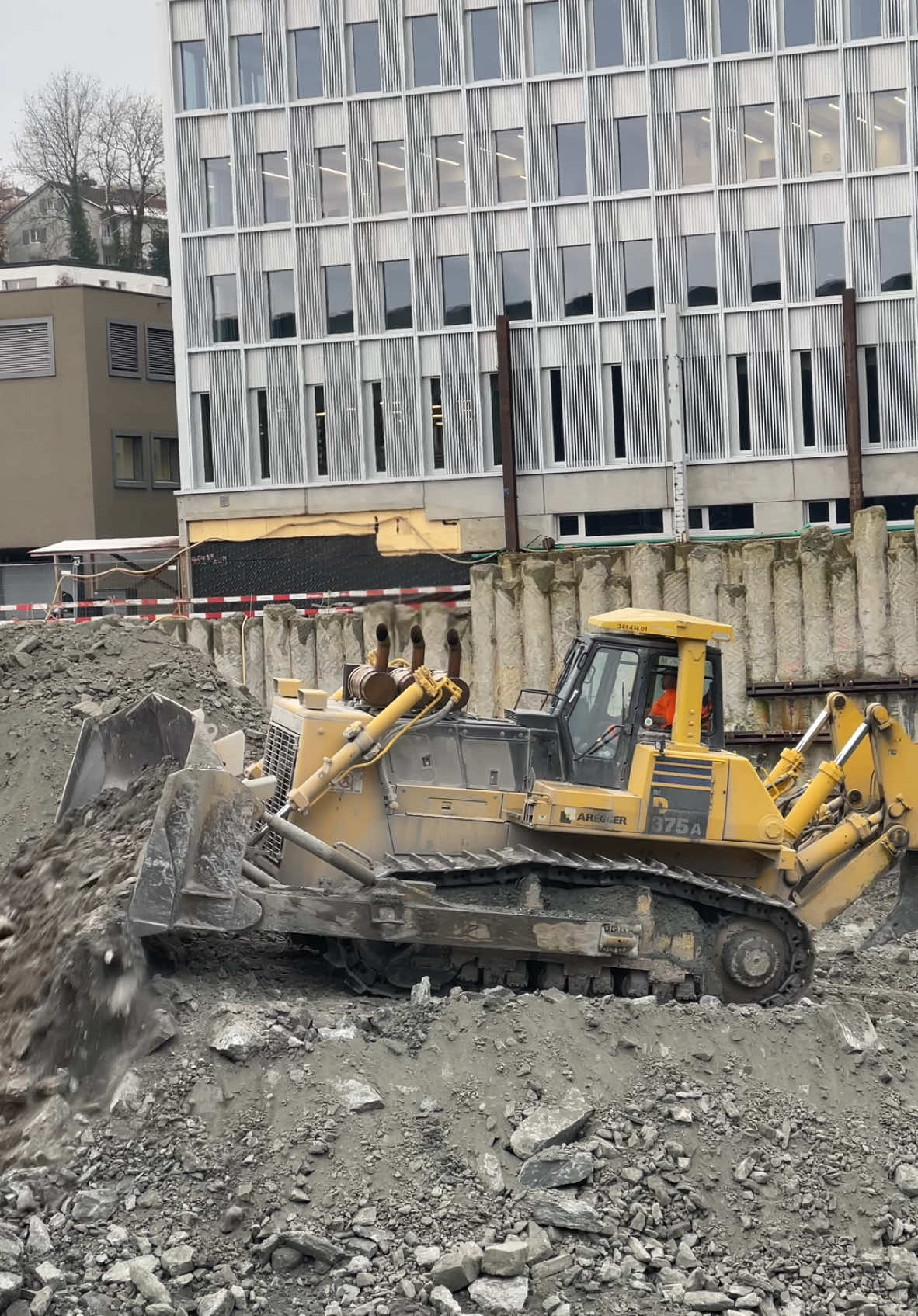 Aregger Komatsu D375A dozer working on a basement excavation in Lucerne, Switzerland