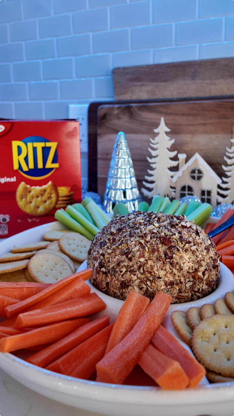 #ad Happy Holidays! What is more nostalgic during the holiday season than a giant cheese ball? This year I decided to make my mom’s holiday cheese ball that she used to make YEARS ago to bring to my husband’s family’s Hanukkah party. I am so glad my mom remembered her recipe, because this was so fun to revive from my childhood! I cannot wait to share it with my husband and his family! RECIPE: 16oz softened cream cheese 1 cup grated cheddar cheese 1/4 cup minced green onions or 2 tbsp chopped chives 1/2 tablespoon Worcestershire sauce 1/2 tbsp ranch powder (or more to taste) 1 cup chopped toasted pecans, for rolling In a bowl blend together cream cheese, cheddar cheese, green onions, ranch powder, and worcestershire. Line a bowl with plastic wrap, and place the mixture in. Cover the mixture in plastic wrap and form into a ball. Place into the fridge until firm. Remove from fridge, and take out of the plastic wrap. Roll the ball in chopped & toasted pecans until fully covered. Serve with RITZ crackers & fresh veggies.  ENJOY @RITZ Crackers  #RITZ #RITZCanada #TasteOfWelcome