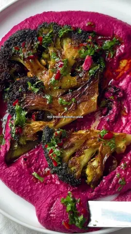 BROCCOLI STEAK + BEETROOT HUMMUS 🔥 this recipe encapsulates how I love to cook best. taking two humble vegetables like broccoli + beetroot. transforming one into ’steaks’, the other into hummus. two elements that come together to create a vibrant, nutritious, flavour-packed plate.  my full recipe for broccoli steaks + beetroot hummus can be found below - so enjoy! and let me know if you give it a go 👇 INGREDIENTS (serves 2) 1 large broccoli 3 beetroots 400g chickpeas (+ some liquid) 4 tbsp tahini 1 tbsp cumin 1 lemon 2 garlic cloves 2 ice cubes 1 tbsp balsamic vinegar 1 tsp red chilli 2 tbsp fresh parsley 1 tsp agave (optional) Salt Pepper Extra Virgin Olive Oil TO SERVE: salad + (flat)breads METHOD 1. Begin with your beetroot. Either boil/roast until knife tender (around 30mins), then peel.  2. In your blender, add the beetroot, chickpeas, tahini, cumin, garlic, lemon juice, cumin + splash of chickpea water. Begin blending to combine.  3. Add the ice cubes one by one whilst the machine runs. Season with salt + blend until creamy/smooth (10min).  4. For the broccoli, slice into steaks (you should get 2). You can serve the rest of the florets on the side if you like.  5. Warm a good glug of olive oil in a frying pan. Sear the steaks on either side, seasoning well, until golden, brown + tender (5 min). Finish in oven if required.  6. For the vinaigrette, whisk together 3 tbsp evo, 2 tbsp balsamic vinegar, chopped chilli, parsley + agave. Season to taste, adjusting acidity / spice as necessary.  7. To serve, spread the hummus in the centre of a plate. Place broccoli steaks on top, then drizzle with the vinaigrette. Serve with flatbread + salad if you like - enjoy! #broccoli #steak #beetroot #hummus #healthyrecipes 