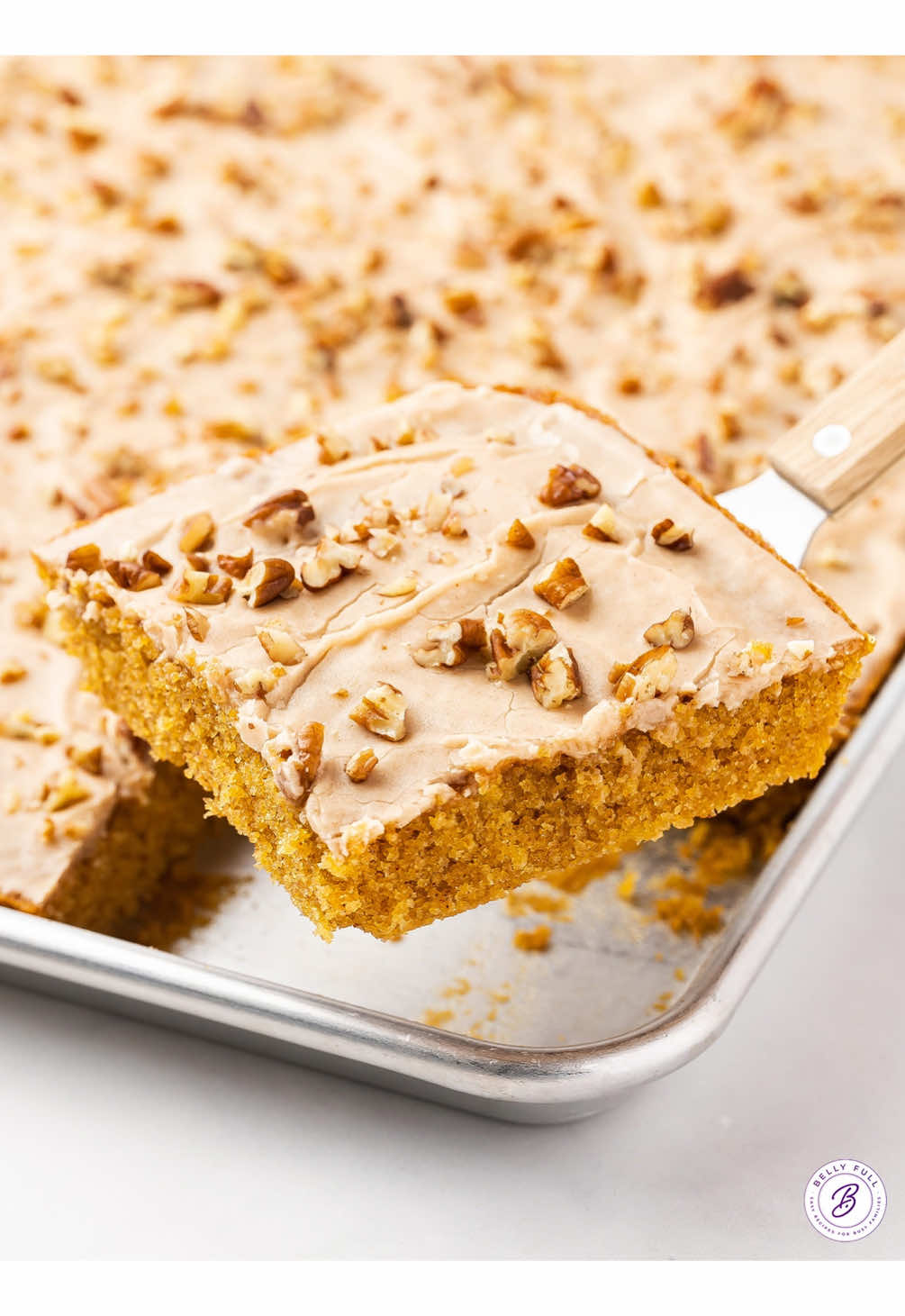 This Pumpkin Sheet Cake recipe is the perfect fall dessert to share with a crowd. The cake is moist and tender, topped with a simple yet irresistible cinnamon frosting. You’ll get at least 15 slices which makes it ideal for sharing at the Thanksgiving or any gathering. #pumpkinsheetcake #sheetcake #pumpkindessert #thanksgivingdessert 