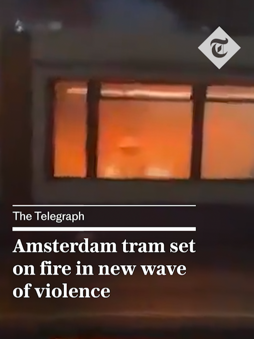 A tram was set on fire in Amsterdam overnight by dozens of rioters in the second wave of violence to rock the Dutch capital in recent days. Footage showed a furious mob – dressed in all black and armed with sticks and fireworks – setting the carriage ablaze, smashing its windows and damaging other properties as police struggled to control the chaos. Police said it was not clear who started the unrest. For more from #thetelegraph, click the link in our bio. #Amsterdam #riots #israel