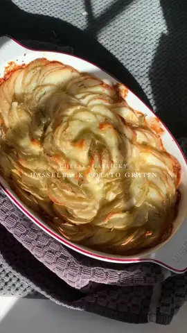 HASSELBACK POTATO GRATIN! It's cheesy. It's garlic-y. It's butter-y. It's anything but a hassle ....unless you're talking about a hasselback LOL I'm testing out recipes as I prepare to host a Thanksgiving meal for my family, and this is definitely one to put on the list for your dinner! FOLLOW along so you don't miss what's coming next! Ingredients: 9-10 medium new white potatoes Olive oil 8 garlic cloves, chopped 2 Tbsp fresh rosemary, chopped Onion salt from TJ's (optional) 2 Tbsp grass-fed butter, cut into small squares Parmesan cheese, cut into thin squares Grass-fed cheddar cheese, cut into thin squares *Optional Greek yogurt or sour cream to garnish Method: Wash potatoes and thinly slice on a mandolin Add slices to a large bowl, drizzle olive oil, add garlic, rosemary, and onion salt (if using) and toss to coat. Arrange slices in a dish, then insert butter squares and cheese slices throughout the dish. Bake in a preheated oven at 350 F for about 45 minutes or until potatoes are baked through and slightly browned on the edges. #potatogratin #thanksgivingmenu #thanksgivingsides #thanksgivingpotatoes #potatorecipe #cheesepotatoes #cheesypotatoes #grassfedbutter #thanksgivingieas #thanksgivingmeal #sidedish #easysidedish #mealideas #thanksgivingmealideas #feedfeed #f52grams #carbs #garlicpotatoes #hasselbackpotatoes #scallopedpotatoes 