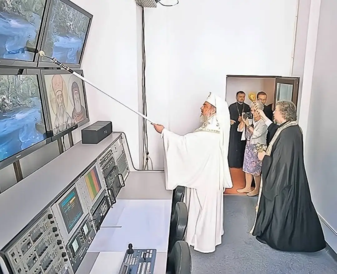 priests and monks blessing server rooms and sprinkling holy water on computer systems as a way to prevent them from ever shutting down