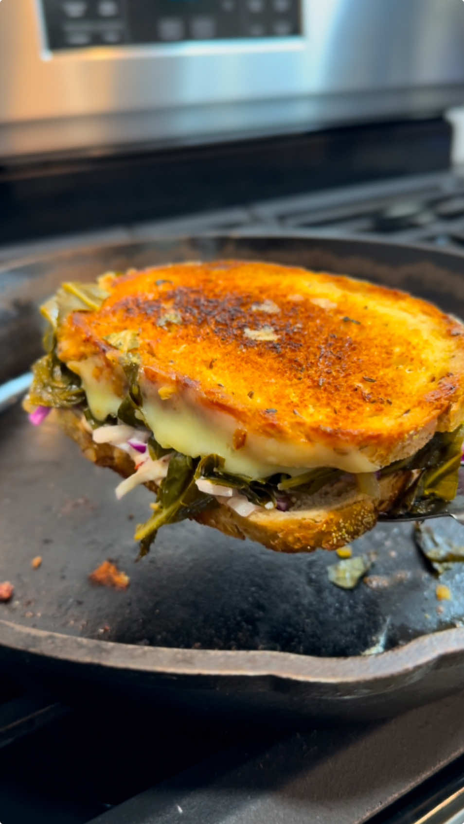 Taking collard greens to the next level with this epic melt 🥪🔥🤤 Collard Greens (adding smoked turkey necks is optional) 8 cups collard greens (3 bunches), cleaned and cut into ribbons 2 Tbsp olive oil 1/2 white onion, diced 4 garlic cloves, minced 32 oz vegetable stock (add more if needed)  1 cup water 2 Tbsp apple cider vinegar 1 Tbsp Creole seasoning (Tony Chachere’s) 1 tsp crushed red pepper flakes 1 Tbsp liquid smoke (hickory) 1 tsp black pepper 1-2 chicken bouillon cubes Instructions: Sauté onion and garlic in olive oil over medium heat. Add stock, water, vinegar, seasonings, liquid smoke, and bouillon. Mix well. Stir in collard greens, bring to a simmer, then reduce heat to low. Cover and simmer for 1-1.25 hours until tender, stirring occasionally. Season to taste. Slaw: 2 cups green cabbage, thinly sliced 1/2 white onion, thinly sliced 2 Tbsp mayonnaise 1 tsp apple cider vinegar 1/2 tsp black pepper 1/4 tsp salt Mix in a medium bowl. Russian Dressing: 1 cup mayonnaise 3 Tbsp pickled hot cherry peppers (Cento brand) 1 Tbsp ketchup 1/2 tsp Worcestershire sauce 1/4 tsp paprika 1/2 tsp black pepper Mix in a large bowl. Sandwich: Rye bread (caraway preferred) Swiss cheese slices Instructions: Lightly oil or butter both sides of the bread, place in a pan over low heat. Add 2 slices of Swiss cheese on one slice of bread. Top with a handful of drained collard greens and slaw. Spread Russian dressing on the other slice of bread, place on top. Press with a sandwich press (or kitchen item), cook until the bread is browned. Flip and press again until the cheese is  melted. Enjoy! #sandwich #food #foodies #foodtiktok 