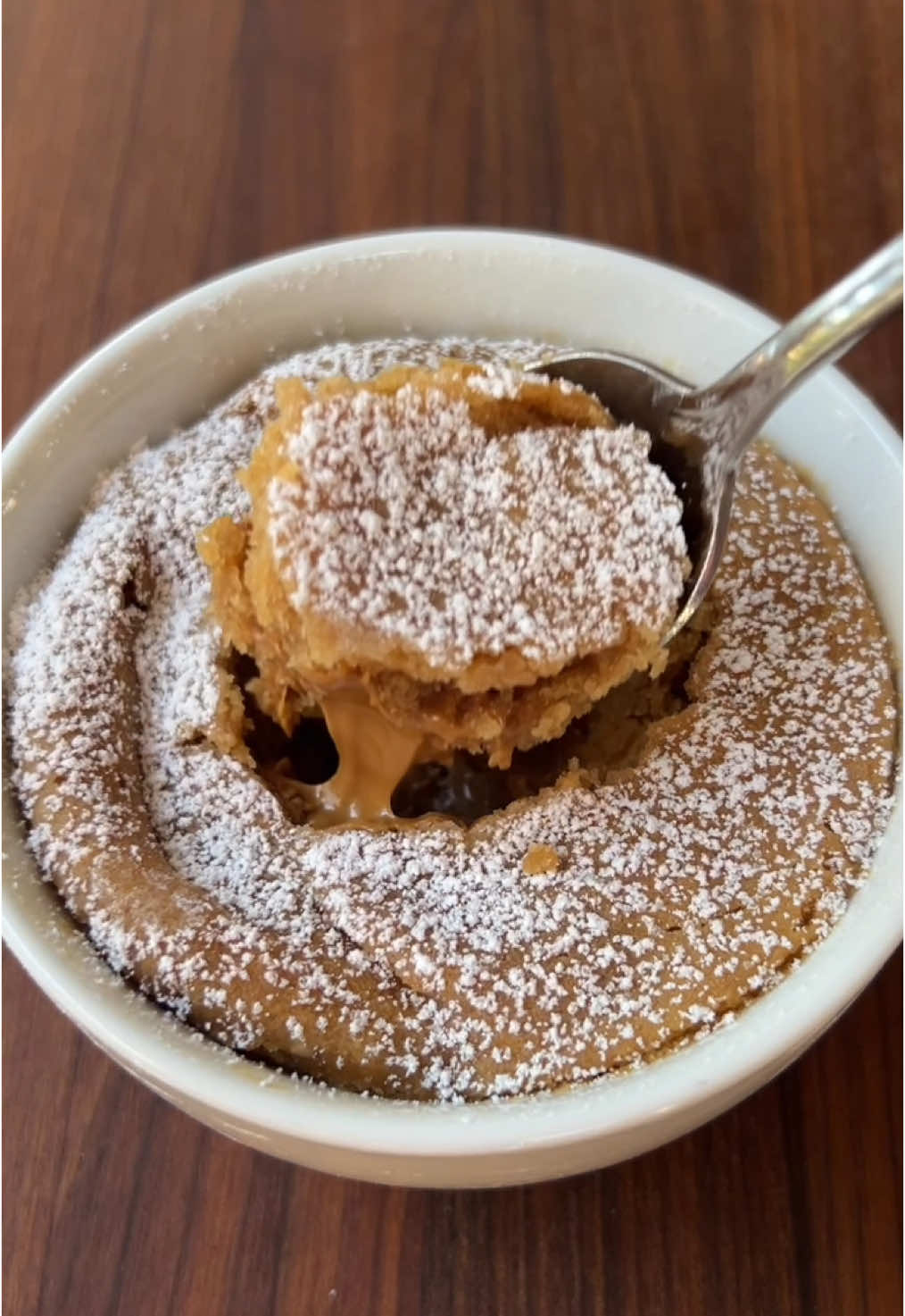 Microwave Cookie Butter Mug Cake! 🍪✨ Ingredients: 1/3 cup + 2 tbs cookie butter 3 tbs self rising flour  1/3 cup milk  Powdered sugar (as needed) Directions: 1. Place 2 tbs of cookie butter in the freezer for 25-30 minutes. 2. Add flour, 1/3 cup cookie butter, and milk to a mug and mix together. 3. Add the frozen cookie butter to the center of batter and microwave for 60-90 seconds.  4. Top with powdered sugar. 