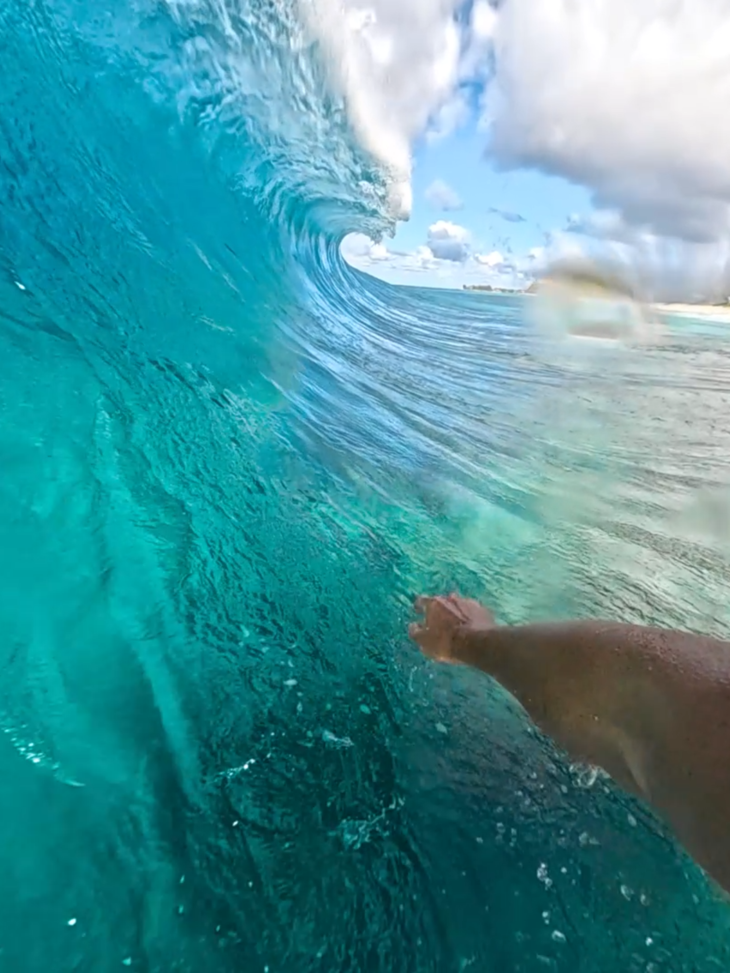surfing the banzai pipleline on a small clear day