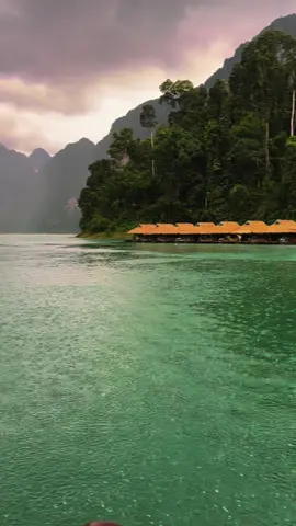 pov: its a rainy day at the floating bungalows in khao sok national park, thailand
