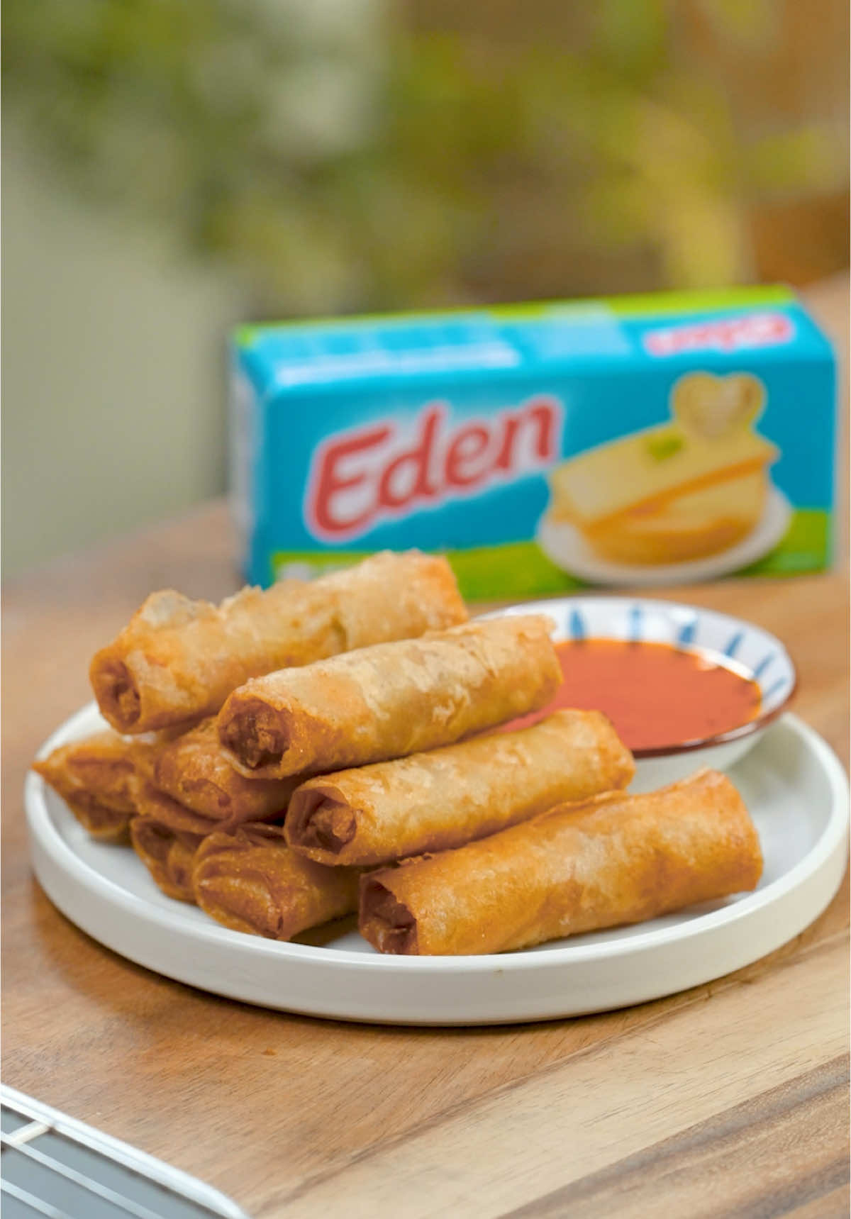 No Pinoy party is complete without lumpia. 🔥 Each small bite is crispy on the outside and juicy on the inside, making it the perfect dish for every occasion! 🤤 This holiday season, kumpletuhin ang saya ng Pasko with Eden Cheese! 🎄 CHEESY LUMPIANG SHANGHAI Ingredients: ½ kg lean ground pork ¼ kg shrimps finely chopped 1 pack Eden cheese, cut into thin strips 1 medium red onion peeled, finely chopped ½ head Garlic peeled, finely chopped 1 large carrot shredded 2 large eggs beaten 3 tablespoons soy sauce 20-25 large lumpia wrapper or spring roll wrapper Salt to taste ground black pepper to taste oil for deep-frying water (for sealing lumpia) Sweet chili sauce (to serve) Procedure: 1. Make the lumpia filling: In a bowl, mix ground pork, chopped shrimps, cheese, onion, garlic, carrot, egg, and soy sauce. Season with salt and pepper to taste. 2. Assemble the lumpia: Place 1 to 1 ½ tablespoons filling on one side of the wrapper and wrap tightly, secure the wrapper by lightly dabbing water on the wrapper edge. 3. In a wok, heat oil over medium heat and deep fry lumpia at medium to low heat for 2 to 3 minutes or until the wrapper turns to golden brown and the filling is cooked. Serve with sweet chili sauce. #fyp #featrmedia #filipinofood #KumpletuhinAngSayaNgPasko #edencheese #lumpia #lumpiangshanghai #cheesy