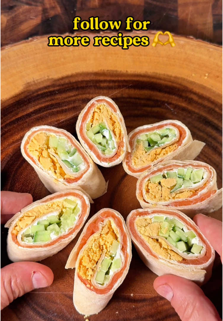 🍣Salmon Tortilla Rolls🤤, recipe👇 Ingredients: - 1 large tortilla - 2–3 tablespoons Philadelphia cream cheese - 1 small cucumber, thinly sliced into strips - 1 small carrot, shredded - 1 wide strip of smoked salmon Instructions: 1. Lay the tortilla flat on a clean surface. 2. Evenly spread the Philadelphia cream cheese across the entire tortilla. 3. Place a row of thinly sliced cucumber strips across one edge of the tortilla. 4. Place a thin layer of shredded carrot on top of the cucumber. 5.  Lay a wide strip of smoked salmon on top of the cucumber and carrot layers. 6. Starting from the edge with the fillings, tightly roll the tortilla into a log shape. 7. Use a sharp knife to cut the roll into small, bite-sized pieces. Arrange the pieces on a plate and serve as a snack or appetizer. Enjoy!😋 #salmon #salmonrecipe #rolls #rollsrecipe #Recipe #recipeideas #snackideas #snackrecipes #food #healthyfood #DinnerIdeas #dinnerrecipes