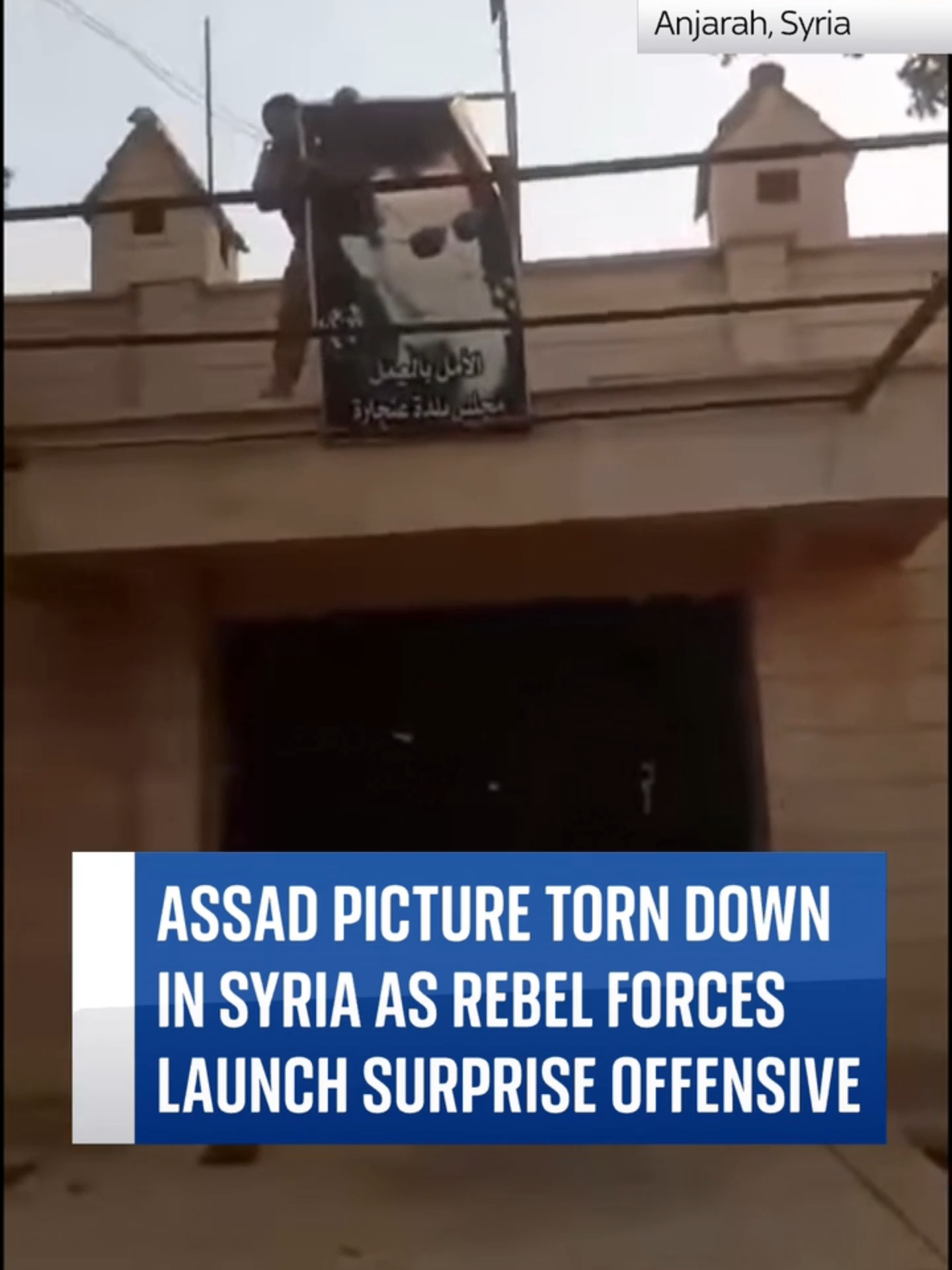 Assad picture torn down in Syria as rebels launch surprise offensive