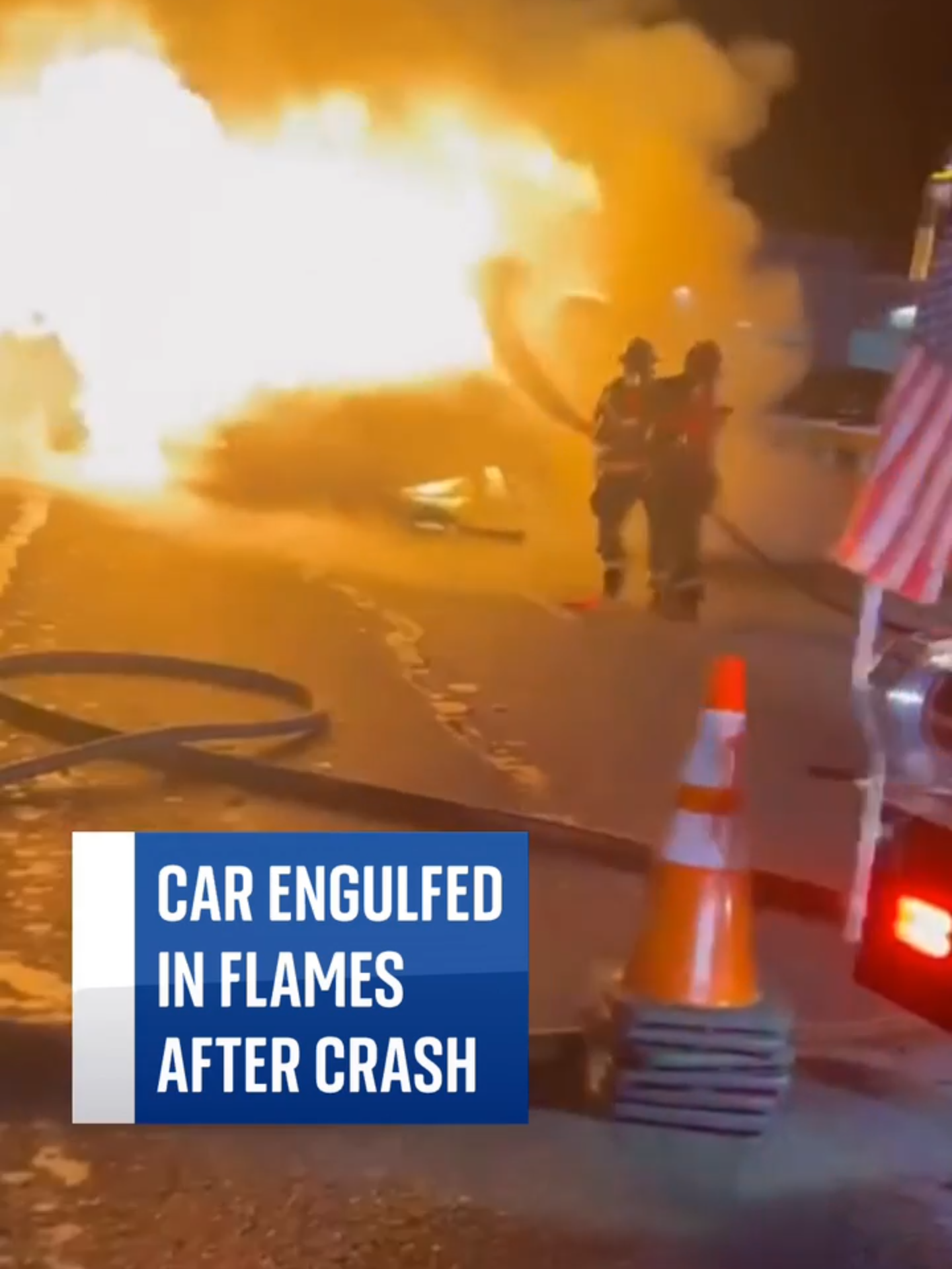 Car engulfed by flames after crash. The two people in the car were able to escape the crash with minor injuries, while firefighters worked to extinguish the flames.