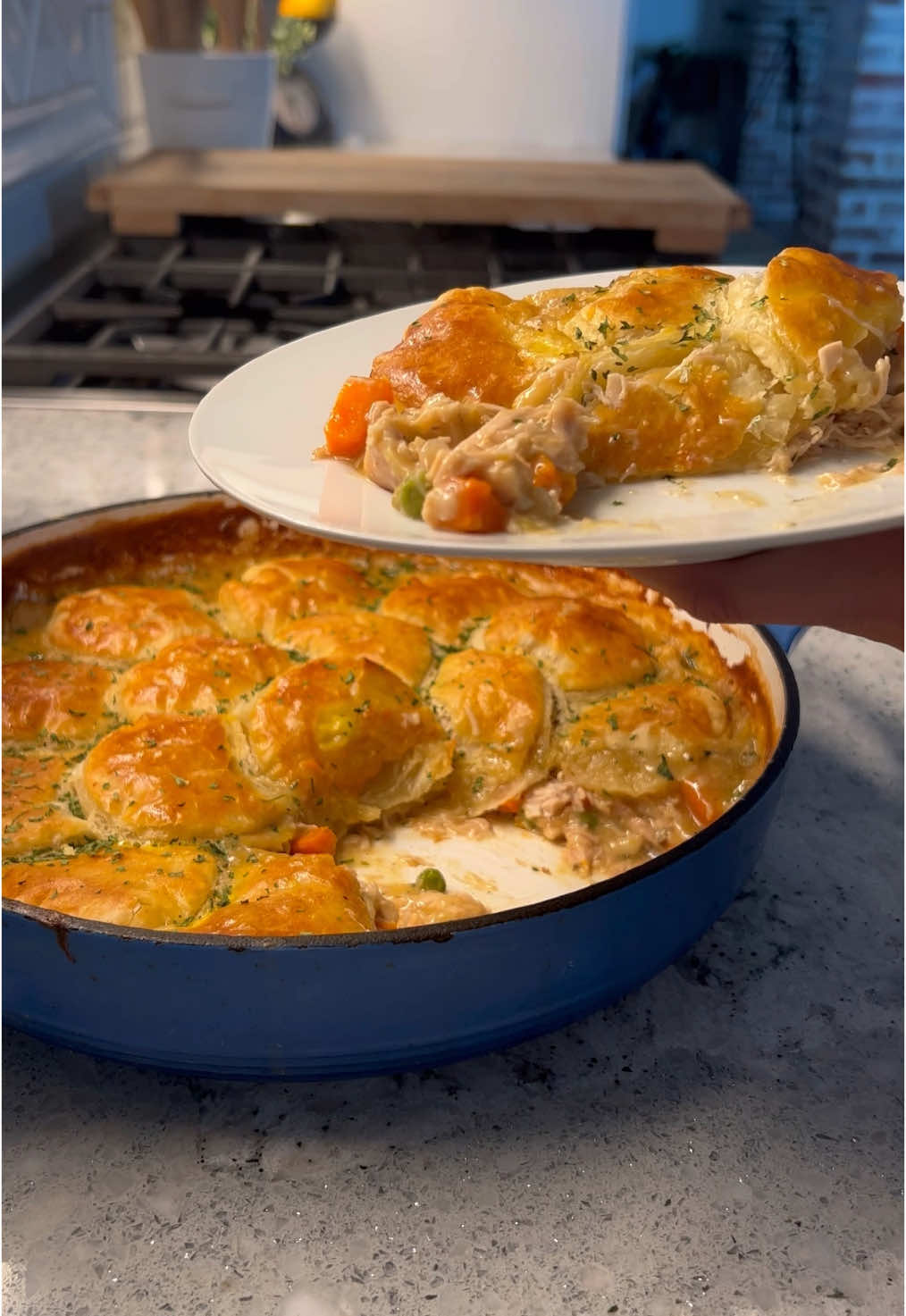 Chicken Pot Pie!  Filling: 	•	½ stick salted butter 	•	½ cup each: diced carrots, onions, celery, mushrooms 	•	1-2 tbsp minced garlic 	•	1 tsp each: Britscookin Cajun seasoning, Britscookin Garlic & Herb & rosemary 	•	2 tbsp butter 	•	⅓ cup flour 	•	2½ cups low sodium chicken broth 	•	½ cup half & half 	•	1 tbsp @betterthanbouillon chicken base 	•	Splash Worcestershire sauce 	•	Shredded rotisserie chicken (or leftover turkey) 	•	1 cup frozen peas Crust: 	•	Puff pastry, cut into rounds 	•	1 egg, beaten Instructions: 	1.	Prepare the filling: 	•	Melt ½ stick of butter in an oven-safe dish or skillet. 	•	Add carrots, onions, and celery. Sauté for a few minutes until softened. 	•	Add mushrooms, minced garlic, Cajun seasoning, Garlic & Herb and rosemary. Stir and cook for another 2-3 minutes. 	•	Add 2 tablespoons butter and ⅓ cup flour. Cook for 2 minutes to form a roux. 	•	Gradually pour in chicken broth and half and half, stirring constantly to avoid lumps. 	•	Mix in Better Than Bouillon and Worcestershire sauce. Stir until thickened. 	•	Add shredded chicken and frozen peas. Combine well. 	2.	Prepare the crust: 	•	Preheat the oven to 425°F  	•	Cut puff pastry into rounds using a biscuit cutter. 	•	Place the rounds on top of the filling. 	•	Brush with egg wash. 	3.	Bake for 20 minutes or until the puff pastry is golden brown. #comfortfood #cozyvibes #Recipe #chickenpotpie #leftoverturkey #yum