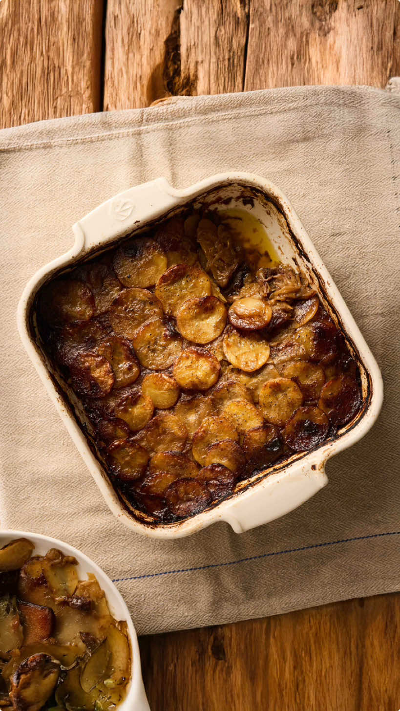 Beef pommes boulangère Prep time 20 mins | Cooking time 180 mins Serves 6   1 Rib cap (optional) 350ml Red wine - 6 Large potatoes (Waxy potatoes – Charlotte, Yukon, Red rooster) 300ml Beef stock  750g Onions (finely sliced) 3 Garlic cloves (finely sliced) 6 Sprigs of thyme (leaves picked) 40g Butter Salt + pepper   - Remove the rib cap from your beef rib, dice into 1-inch squares and place in red wine for 6 hours if you have the time, otherwise jump straight into the cooking. Strain the marinated beef from the red wine and dry, season and in a large frying pan over a high heat colour the beef all over. Add the red wine, bring to the boil and place in the oven covered with foil at 140C fan or 160C for 2 hours. Check, the meat should break down easily and the red wine should have reduced into a sauce consistency.   - Peel your onions and slice finely, cook in a pan over a medium heat for around 5 minutes before adding sliced garlic cloves. Cook until the onions are soft and golden brown.Check seasoning and add the picked thyme.   - Peel the potatoes and slice thinly with a knife or on a mandolin, season with salt and pepper. Get your dish and start with a layer of braised beef followed by potatoes, add some stock followed by a layer of onions. Repeat but this time no beef, more potatoes, stock and onions and finish with a layer of potatoes and some more stock to around ½ cm above the potatoes. Add your butter. Cook in the oven at 180C fan or 200C for 1.5 hours covered. Then remove the lid and place into the oven at 210C fan or 230c until nicely coloured all over. In the telegraph this weekend! 📸 @thomatkinson #potato #beef #onion #christmas #gratin 