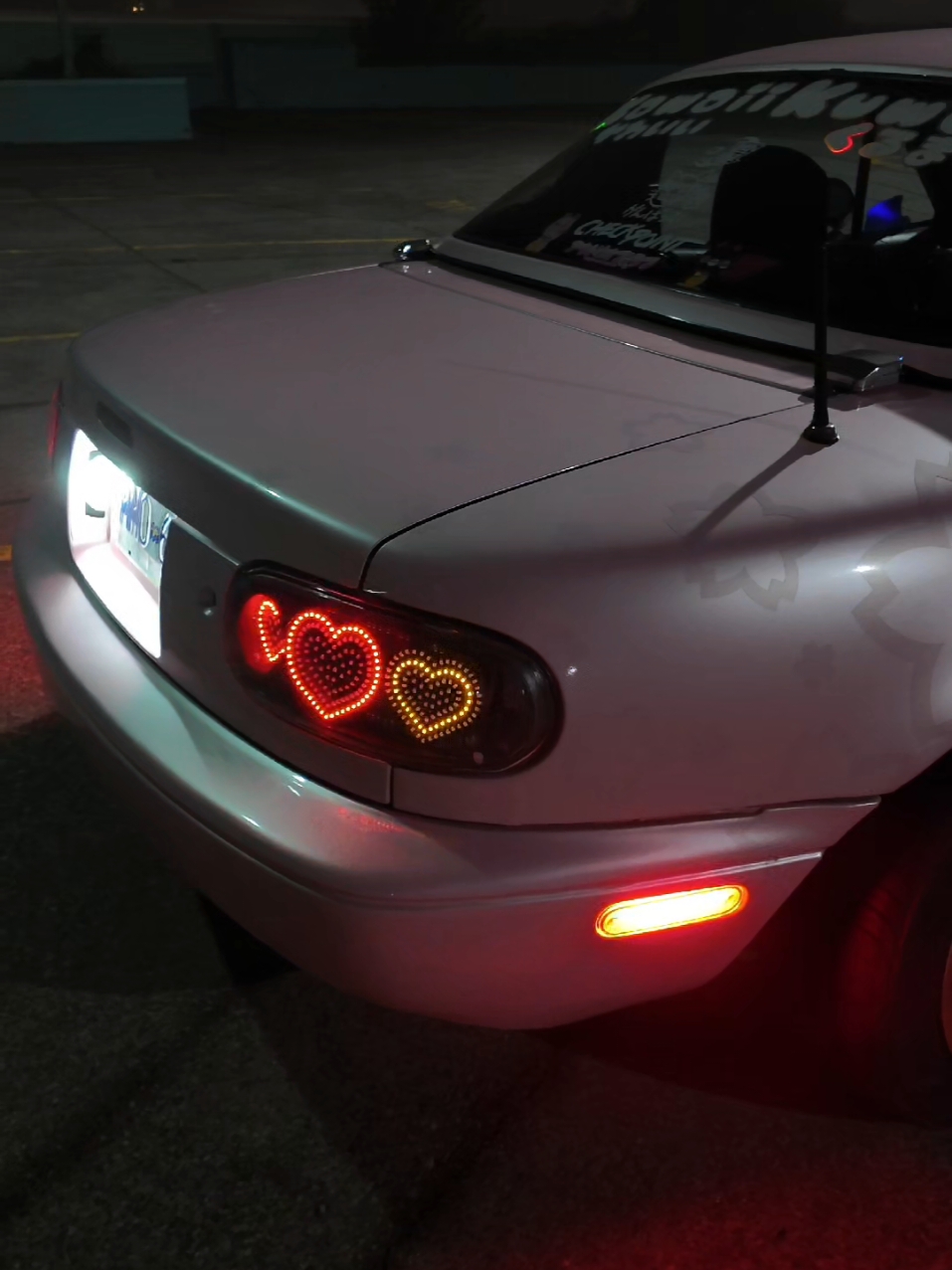 night time is the right time to capture my pink Miatas custom heart tail lights at their best (⁠｡⁠･⁠ω⁠･⁠｡⁠)⁠ﾉ⁠♡ the ghost finish Sakura cherry blossom livery kit also looks its best at night time!!! spring can't come any sooner, I need some night time cherry blossom pictures! #pinkcar #pinkmiata #customtaillights #livery #cutecar #miata 