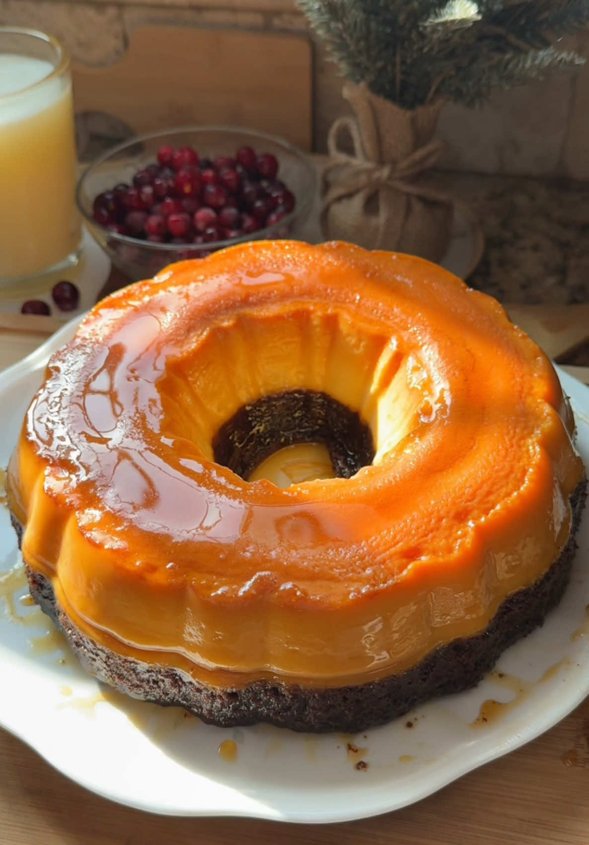 Chocoflan🎄🍮🍫✨                                             Recipe:                                                                            Ingredients  Caramel 1 cup granulated sugar (200g) Queso Flan 12oz evaporated milk  14oz sweetened condensed milk  4oz cream cheese, softened  1 Tbsp vanilla 4 eggs, room temperature  Chocolate cake: 1 cup + 2 Tbsp all-purpose flour, sifted (135g)  1 cup granulated sugar (200g) 2 Tbsp cornstarch, sifted  1/3 cup unsweetened cocoa powder, sifted (30g) 1 tsp baking soda 1 tsp baking powder  3/4 tsp salt 1 cup vegetable oil (236ml)  1 cup + 1 Tbsp milk, room temperature (250ml) 1 Tbsp vanilla  2 eggs, room temperature Instructions  For the caramel: 1. Grease a 10-inch bundt pan. 2. Melt sugar over medium-low heat, constantly stirring to prevent the sugar from burning. The sugar will turn into a bunch of small clumps, which is normal. Keep stirring until it’s fully melted. 3. Pour melted sugar into bundt pan. Be careful because the pan gets hot. For the queso flan: 1. Preheat oven to 375°F. 2. In a large bowl whisk together evaporated milk, sweetened condensed milk, and cream cheese until smooth and no clumps. You can add it to a blender to speed this up. 3. Add vanilla and eggs. Whisk until fully combined. 4. Pour into the bundt pan using a sifter so there are no clumps of egg. 5. Cover with aluminum foil and bake using a water bath. Put the bundt pan in a roasting pan and fill the roasting pan with water until it reaches half way to the bundt pan, or up to where the flan reaches. 6. Bake for 40-45 minutes. For the chocolate cake: 1. While the flan is in the oven, in a medium bowl whisk together flour, sugar, cornstarch, cocoa powder, baking soda, baking powder, and salt. Set aside. 2. In a large bowl whisk together vegetable oil, milk, vanilla, and eggs until combined. 3. Fold in the dry ingredients into wet ingredients. 4. Remove roasting pan from oven. Uncover the flan and SLOWLY pour the chocolate cake batter over the flan. If you want to be extra careful use a measuring cup to pour it a little at a time.  5. Cover the bundt pan with a greased aluminum foil.  6. Bake at 350°F for 50 minutes to 1 hour (start checking at 45 minutes). Once baked, immediately remove bundt pan from the water bath and let it cool completely. Then, place in fridge for at least 3 hours or overnight. 8. Once chilled, use a toothpick to loosen the edges. Place a plate on top of the bundt pan and flip. Give it a few taps and it should come out easily.  #chocoflan #flan #christmas #baking #Recipe #bakingtiktok #recipeideas #christmasbaking #christmastiktok #bakingvideo #dessert #foryou #bakingtherapy #baketok #fyp 