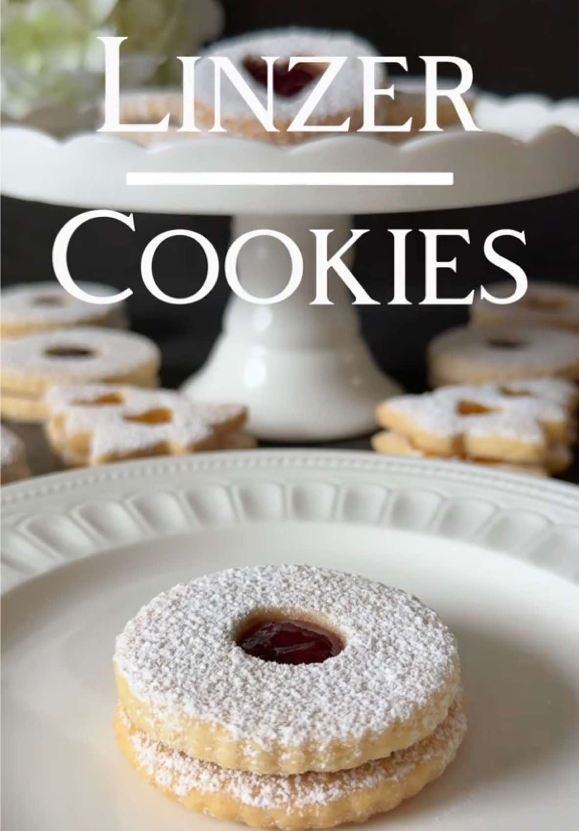 Linzer Cookies 🤍 These delicate, buttery Linzer cookies filled with jam are a true classic and taste absolutely heavenly. 🥰 Ingredients (yields approx. 20 sandwich cookies): For the dough: •	250 g all-purpose flour (about 2 cups) •	150 g cold, cubed butter (about ⅔ cup) •	100 g ground blanched almonds (about 1 cup) •	100 g powdered sugar (about ¾ cup) •	1 egg yolk •	1 tsp vanilla extract •	A pinch of salt For the filling: •	Jam of your choice For decoration: •	Powdered sugar for dusting 🤍 Instructions: 1.	Combine flour, powdered sugar, ground almonds, and salt in a bowl. Add the cold butter cubes and process into a crumbly mixture. 2.	Add the egg yolk and vanilla extract. Quickly knead into a smooth dough. Shape the dough into a flat disk, wrap it in plastic wrap, and refrigerate for at least 1 hour. 3.	Preheat the oven to 180°C (350°F) top/bottom heat (160°C fan). Line two baking sheets with parchment paper. 4.	Roll out the dough on a floured surface to about 3–4 mm thick. Cut out circles (approx. 5 cm in diameter) or other shapes (e.g., hearts, flowers). Use a small cutter to create a hole in the center of half the shapes. 5.	Place the cookies on the prepared baking sheets and bake for 10–12 minutes. They should remain light in color and only turn slightly golden at the edges. Keep an eye on them after 9 minutes. The cookies will be soft when they come out of the oven but will firm up as they cool. 6.	Spread a thin layer of jam on the bottom cookies (the ones without holes). 7.	Dust the top cookies (the ones with holes) with powdered sugar before gently placing them on the jam-covered cookies. Optionally, lightly dust the sides of the cookies with powdered sugar as well. Enjoy baking and indulging in these delightful cookies! 🤍