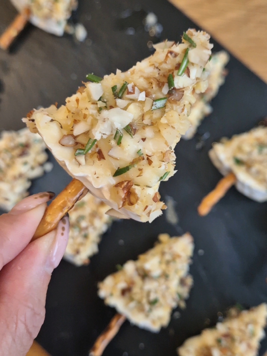 - Ingredients -  ▪️Brie/Camembert ▪️Pretzel sticks ▪️Honey  ▪️Fresh rosemary ▪️Fresh thyme ▪️Mixed nuts (walnuts, pecan, peanut)  Cut the cheese into triangles and slice each piece lengthwise again. Stick 1/2 a pretzel stick into the bottom and you have your cute little Christmas tree shape.  Chop up finely your fresh herbs and mixed nuts of choice (throw in some chilli powder for a little kick).  Pour some honey on a plate. Dip in your brie christmas tree cheese-side down, into the honey and then into your mixed nuts and ta-da!   ----------  You can cut up the cheese ahead of time - Prep and making takes about 10-15 mins. These were very tasty and a very quick and easy appetiser level to make.  Enjoy!  #brie #brierecipe #nocookrecipe #christmas #christmasrecipe #christmasappetisers #appetisers #cheeseappetisers #christmastree #xmasrecipe #xmasappetisers #christmasfood #EasyRecipe #EasyRecipes #easyappetisers #holidayappetisers #trendingfood #christmasstarters 