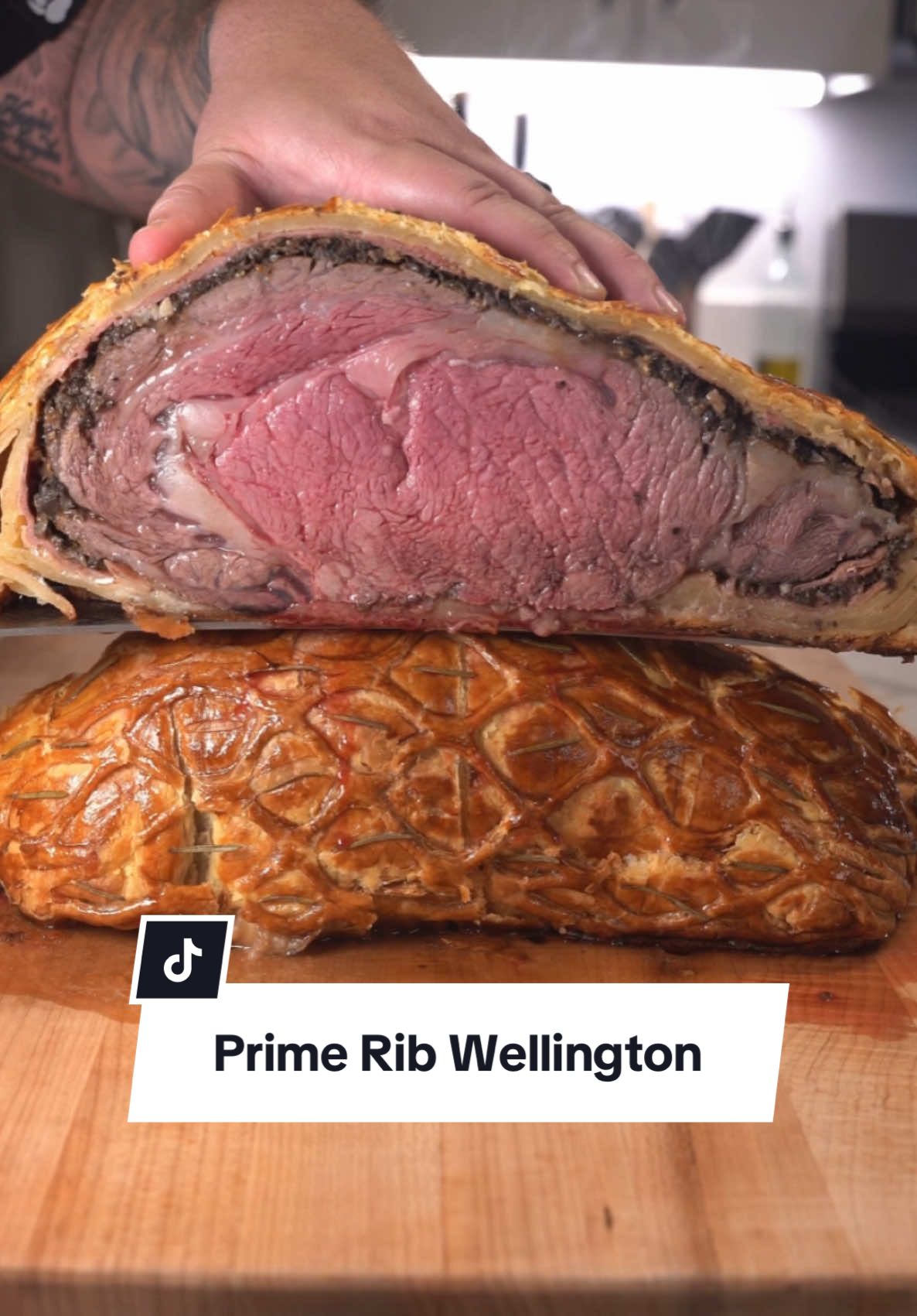 Worlds First Prime Rib Wellington  Full Recipe  ⤵️⤵️⤵️ Ingredients: Prime Rib @Omaha Steaks  2 oz Mustard 1 oz Salt  1 oz Pepper 1 lb Baby Bella Whole Mushrooms  2 Shallots  6 Garlic Cloves  3 ounces of Red Wine  12 ounces Prosciutto 4 Sheets Puff Pastry 1 Bunch Rosemary  4 egg Yolks Instructions 1. Prep the Prime Rib 	1. Sear the Prime Rib in a hot skillet on all sides until browned. 	2. Brush the seared Prime Rib with mustard, then season generously with salt and pepper. Set aside to cool. 2. Make the Mushroom Duxelles 	1.	In a skillet over medium-high heat, cook the minced mushrooms, shallots, and garlic. 	2.	Add the red wine and stir until all the liquid has evaporated and the mixture is dry. Set aside to cool. 3. Assemble the Wellington 	1.	Lay plastic wrap on a flat surface. Arrange the prosciutto slices on the plastic wrap, overlapping slightly to create a large sheet. 	2.	Spread the cooled duxelles mixture evenly over the prosciutto. 	3.	Place the seasoned Prime Rib on top and use the plastic wrap to tightly wrap the prosciutto and duxelles around the Prime Rib. Twist the ends of the plastic wrap to secure. Refrigerate for 15 minutes. 4. Wrap in Puff Pastry 	1.	Roll out the puff pastry sheets into a large rectangle. 	2.	Remove the plastic wrap from the Prime Rib and place it on the puff pastry. Wrap the pastry around the meat, sealing the edges tightly. Trim any excess pastry. 	3.  Brush the entire surface with egg yolks for a golden crust. Garnish with rosemary, if desired. 5. Bake or Smoke the Wellington 	1.	Place the wrapped Prime Rib on a parchment-lined baking sheet. 	2.	Smoke or Bake at 425°F (220°C) until the internal temperature in the thickest part reaches 120°F for medium-rare, approximately 1 hour and 40 minutes for this 6 lb cut.  	3.	Remove from the oven and let rest for 20 minutes. 6. Serve 	•	Slice into thick portions and serve warm. Pair with your favorite side dishes or a red wine sauce for an elegant meal  Smoker @GMG  Knifes @THE COOKING GUILD  #primerib #wellington #holidayrecipes #recipes #omahapartner 