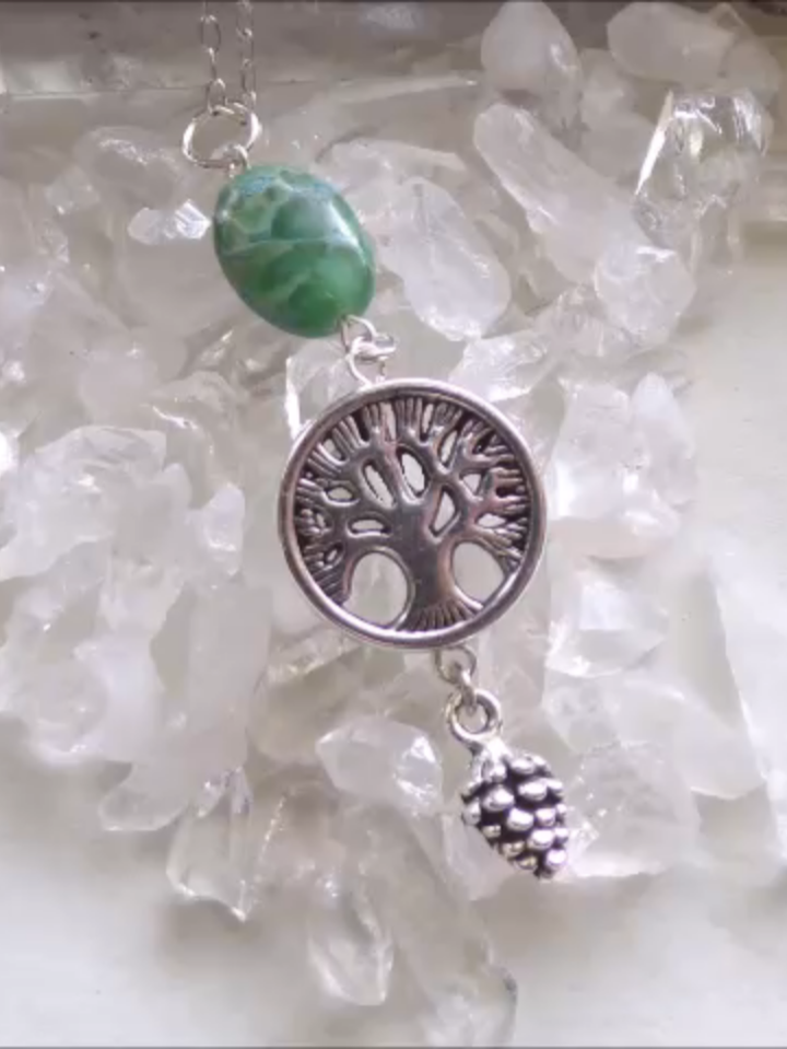 Silver Tree of Life Green Variscite Stone Pendant Necklace - The tree of life symbolism is seen in the mythologies of almost every civilization on earth. It is related to the sacred tree in both religious and philosophical traditions. While the tree of knowledge connects heaven to the underworld, the tree of life connects all living things. Variscite can help with past life work and astral travel, and is also known to ease depression and anxiety. It is a good meditation stone and can aid in balancing emotion with logic. It is said to increase self-reliance and moral courage. https://mymysticgems.com/products/silver-tree-of-life-green-variscite-stone-pendant-necklace