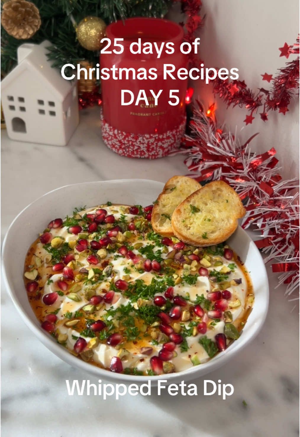 Christmas recipes- Day 5 Whipped Feta dip with pomegranate & pistachios & Bring this one to your next party or serve as a Christmas appetizer. To make: In a food processor blend a block of Feta with 3/4 cup of Greek yogurt, 2 roasted garlic gloves, drizzle of honey & salt. Top with hot honey, pistachios, pomegranate & fresh parsley. Enjoy! #whippedfeta #diprecipe #christmasdip #christmasrecipe #holidayappetizer