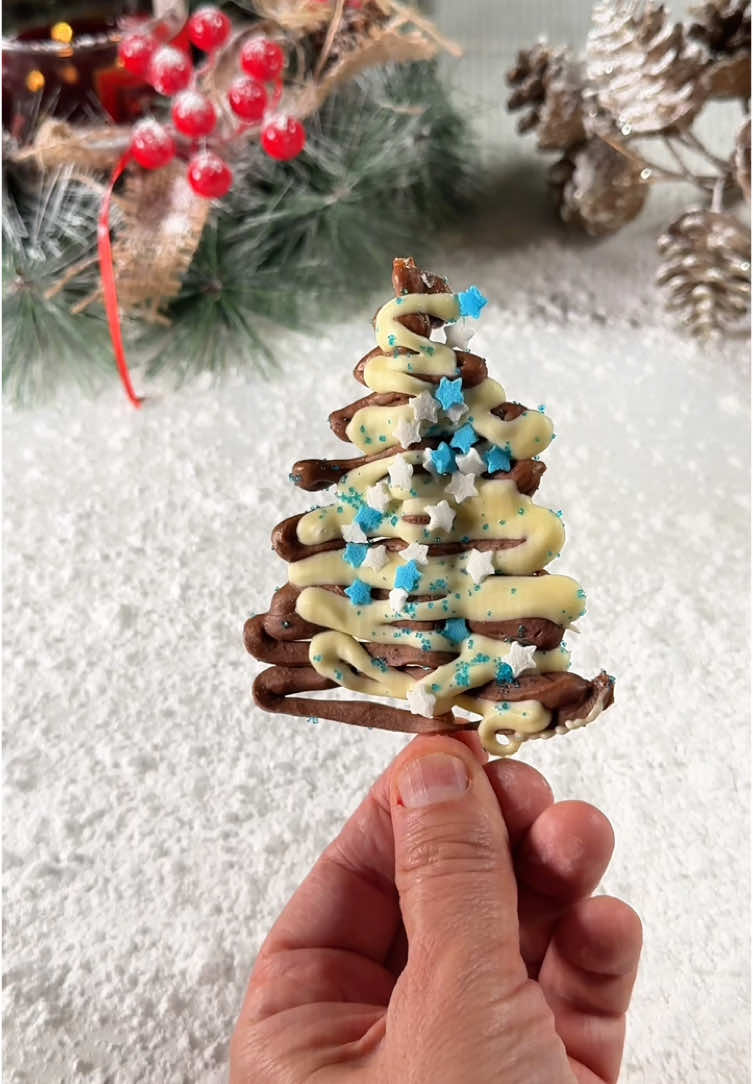 🎄Chocolate Christmas Tree Sticks🤤, recipe👇 Ingredients: - Thin breadsticks   - 2 Milka chocolate bars (1 white, 1 dark)   - Christmas sprinkles   Instructions: 1. Place the thin breadsticks on a sheet of parchment paper.   2. Break the dark chocolate and white chocolate into pieces. Place each type in separate microwave-safe bowls. Melt in the microwave in 15-20 second intervals, stirring in between until smooth.   3. Using a spoon or a piping bag, drizzle the dark chocolate over the breadstick in a wavy pattern to resemble a Christmas tree.   4. Drizzle white chocolate over the top in small amounts for a decorative touch.   5. Add Christmas sprinkles to the chocolate before it sets. Place the decorated breadsticks in the freezer for 10-15 minutes until the chocolate is firm.   6. Remove from the freezer and enjoy your festive chocolate Christmas tree sticks!   🎄Perfect for a holiday!😋🫶🏼 #Recipe #recipeideas #dessert #dessertideas #food #healthyfood #delicious  #dessertrecipe #chocolate #chocolatelover #chocolaterecipes #christmas #christmasrecipes #christmastreats 