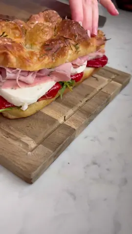 ✨ THE 12 DAYS OF BREADMAS ✨Day 2: Focaccia Slab Sandwiches. A quick and easy option for feeding a crowd! This is one of the recipes from my upcoming cookbook 3 Doughs, 60 Recipes (link to preorder is in my bio). My book is out in early spring next year, but if you’d like to gift it to the bread lover in your life, I have a downloadable gift card that you can wrap up to let them know their pressie is on the way (PDF download link is also in my bio!)…becayse people always ask, the link to the the tray can be found by clicking “shop my baking favorites” in my bio link!  It’s quite self explanatory but here is how to do it…cut your entire slab of focaccia horizontally and pile high with the spreads and toppings of your choosing. Once the slab is assembled, simply cut to desired size and serve alongside some salads and you have yourself an easy peasy party spread. I find each slab yields 15-16 smaller sandwiches (cut 3x5 or 4x4) or 8-10 full sized sandwiches (cut 2x4 or 2x5).  This slab sandwich features my Herby Olive Dipping Oil (also a recipe from my cookbook), arugula, roasted peppers, mozzarella and some herby ham (for those who want a meat option). You can fill your slab sandwich with whatever you desire!  Other sandwich flavour ideas: ▫️Pesto, mozzarella, tomatoes, basil and arugula  ▫️Pesto, mortadella, stracciatella cheese and pistachio  ▫️Chimichurri, grilled peppers and onions, mozzarella (or chicken/steak) ▫️Classic turkey or ham with cheese, avocado and all the sandwich fixings  ▫️ Italian grinder with Italian deli meats, sliced cheese and grinder salad ▫️Cream cheese, olive tapenade, grilled veggies, arugula ▫️ Buffalo chicken, ranch, avocado, lettuce, tomato and red onion  ▫️ BBQ pulled pork, bbq sauce and slaw The possibilities are endless! What will you put on yours?  #focaccia #christmas #christmasfood #holidayfood #feedingacrowd #partyrecipes #breadlover #sandwichrecipe #sandwich #foodporn 