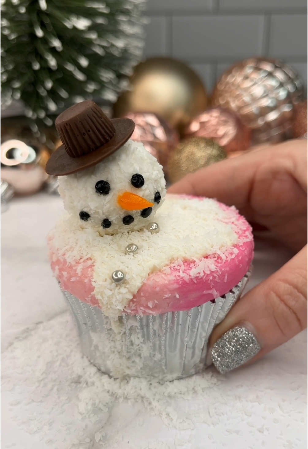 Melting snowmen ☃️🫠 24 days of Christmas treats 🎅🏼🧁🍪 ☃️ I started with a multi coloured flat top on my cupcake. ☃️ I added white chocolate ganache and shredded coconut on top. ☃️ For his head l used ferrerorocher raffaello.  ☃️His face is piped using black and orange buttercream.  ☃️ I made his hat with a mini reeses and a chocolate button. #cupcake #christmasbaking #snowman #cakeart #bakinginspo #cakedbyrach #christmastreats #christmascountdown #christmastreats #christmastiktok 