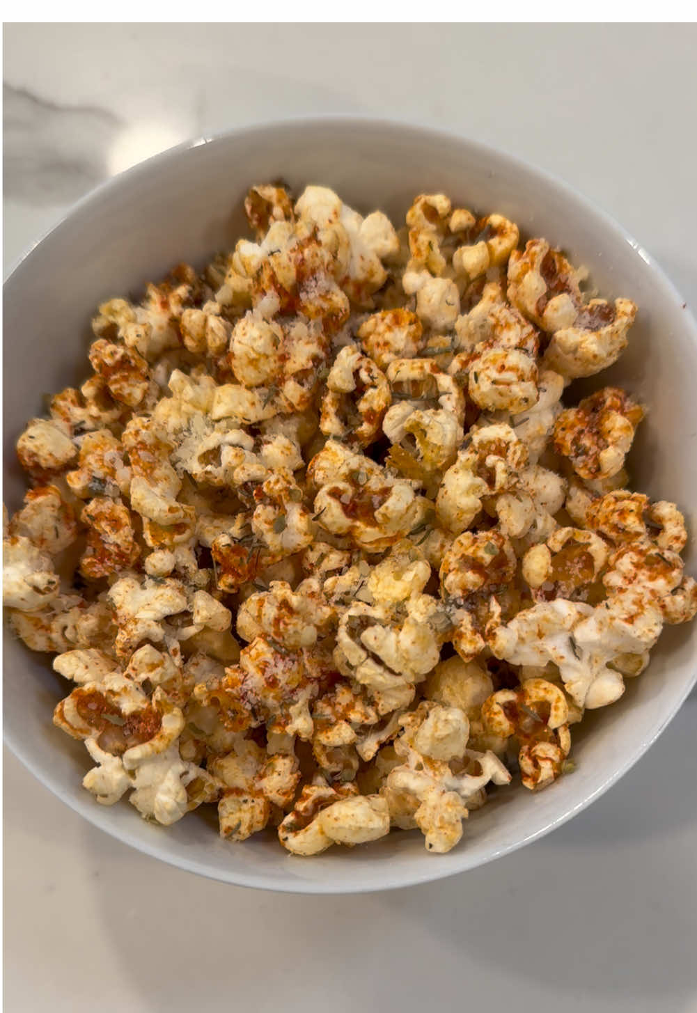 Pizza popcorn. I’ll be bringing this as an appetizer for a Christmas party tomorrow night.  A lot of this recipe is “to taste” but you can start here and adjust according to your preference: 2 tablespoons of oil (I used leftover oil from a jar of sundried tomatoes) 3 tablespoons popcorn kernels 2 tablespoons salted butter Dash of salt 2 tablespoons tomato powder Dash of thyme Dash of oregano 2 tablespoons parmesan cheese (Add some red chili flakes for heat if that’s your vibe) #popcorn #homemadepopcorn #pizza #fyp #christmasrecipe #christmasappetizer #movienight #creatorsearchinsights 