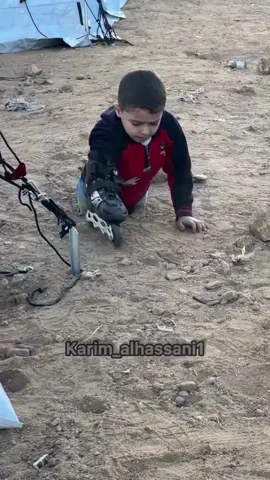 A Palestinian child in Gaza City, both legs amputated, is using rollerskates in one hand to navigate the rugged terrain between tents in a displacement camp. This is the result of the unhinged Isr*li occupation's indiscriminate b**bing of Gaza, targeting residential homes, violating every international law, and denying children like him access to treatment through its absolute siege and blockade.