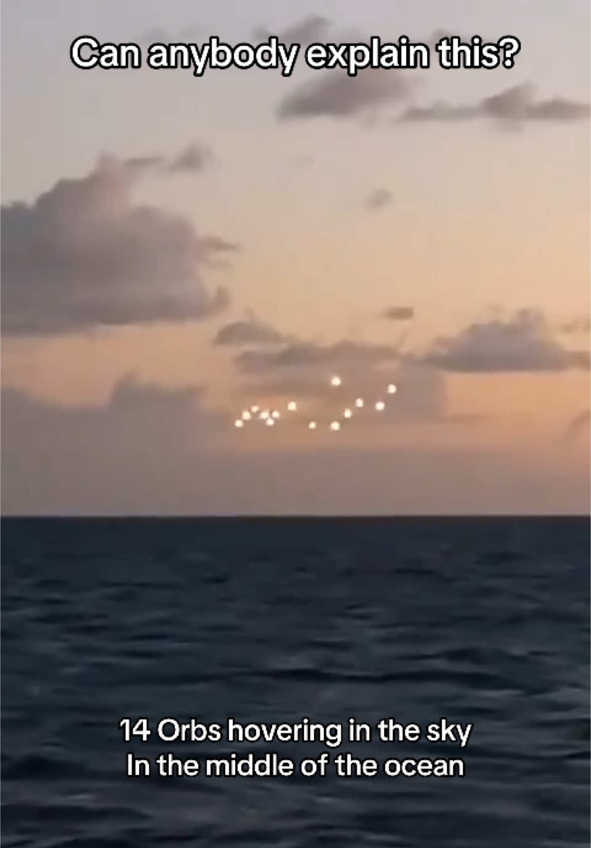 Video showing a cluster of 14 orbs hovering in the sky over the oceans off of New Jersey. Can anybody explain this? We have heard countless theories as to what they could be and none of them seem to add up. 