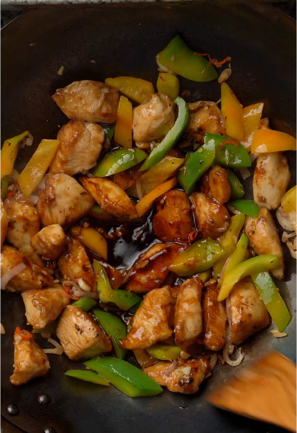 Stir-Fried Chicken with Green Pepper and Thai Chili Ingredients: * For the Chicken Marinade:     * 300 g chicken breast or thighs, sliced     * 1 tablespoon dark soy sauce     * 1 tablespoon light soy sauce     * ½ teaspoon black pepper     * 1 teaspoon cornstarch * For the Stir-Fry:     * 1 tablespoon oil     * 2 garlic cloves, minced     * 2 shallots, thinly sliced     * 2-3 Thai chilies, finely chopped (adjust to taste)     * 1 green bell pepper, sliced into strips * For the Sauce:     * 1 tablespoon light soy sauce     * 1 tablespoon dark soy sauce     * 1 tablespoon fish sauce     * 1 tablespoon oyster sauce     * 1 teaspoon sugar     * ½ teaspoon MSG (optional) * To Finish:     * Fresh coriander leaves, roughly chopped     * Juice of ½ lime     * Steamed jasmine rice, for serving Instructions: 1. Marinate the Chicken:     * Combine the chicken with dark soy sauce, light soy sauce, black pepper, and cornstarch. Mix well and let it marinate for 10 minutes. 2. Cook the Chicken:     * Heat oil in a pan or wok over medium-high heat. Add the chicken and stir-fry until cooked through. Remove from the pan and set aside. 3. Stir-Fry Aromatics and Vegetables:     * In the same pan, add garlic, shallots, and Thai chilies. Stir-fry until fragrant. Add the green bell pepper and cook for 2-3 minutes until slightly softened. 4. Make the Sauce:     * In a small bowl, mix light soy sauce, dark soy sauce, fish sauce, oyster sauce, sugar, and MSG. Pour the sauce into the pan, stirring to coat the vegetables. 5. Combine Everything:     * Return the cooked chicken to the pan and toss to combine with the sauce and vegetables. Cook for 1-2 minutes to heat through. 6. Add Final Touches:     * Remove from heat and stir in fresh coriander and lime juice. 7. Serve:     * Serve hot over steamed jasmine rice.  #EasyRecipes #EasyRecipe #Recipe #cooking #food #chickenrecipes #stirfry #spicyrecipes #stirfryrecipe #streetfood 