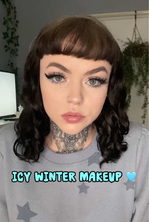 this was a super fun alternative look to create for winter time 🩵 all of the sparkles remind me of sunlight reflecting on a fresh snow ✨ . . . . . (( #winter #wintermakeup #makeupinspo #makeupideas #holidaymakeup #alternativegirl #alternativemakeup #glitter #wingedliner #altgirl #egirl #bangs #lashes #curls #throattattoo #grwm #purplemakeup #eyeshadow #sparklymakeup #domymakeupwithme #girlswithtattoos #inkedgirls #greeneyes #simplemakeup #motd #makeuptutorial #makeuptransformation #snowy #fluffybrows #girlswithpiercings )) 