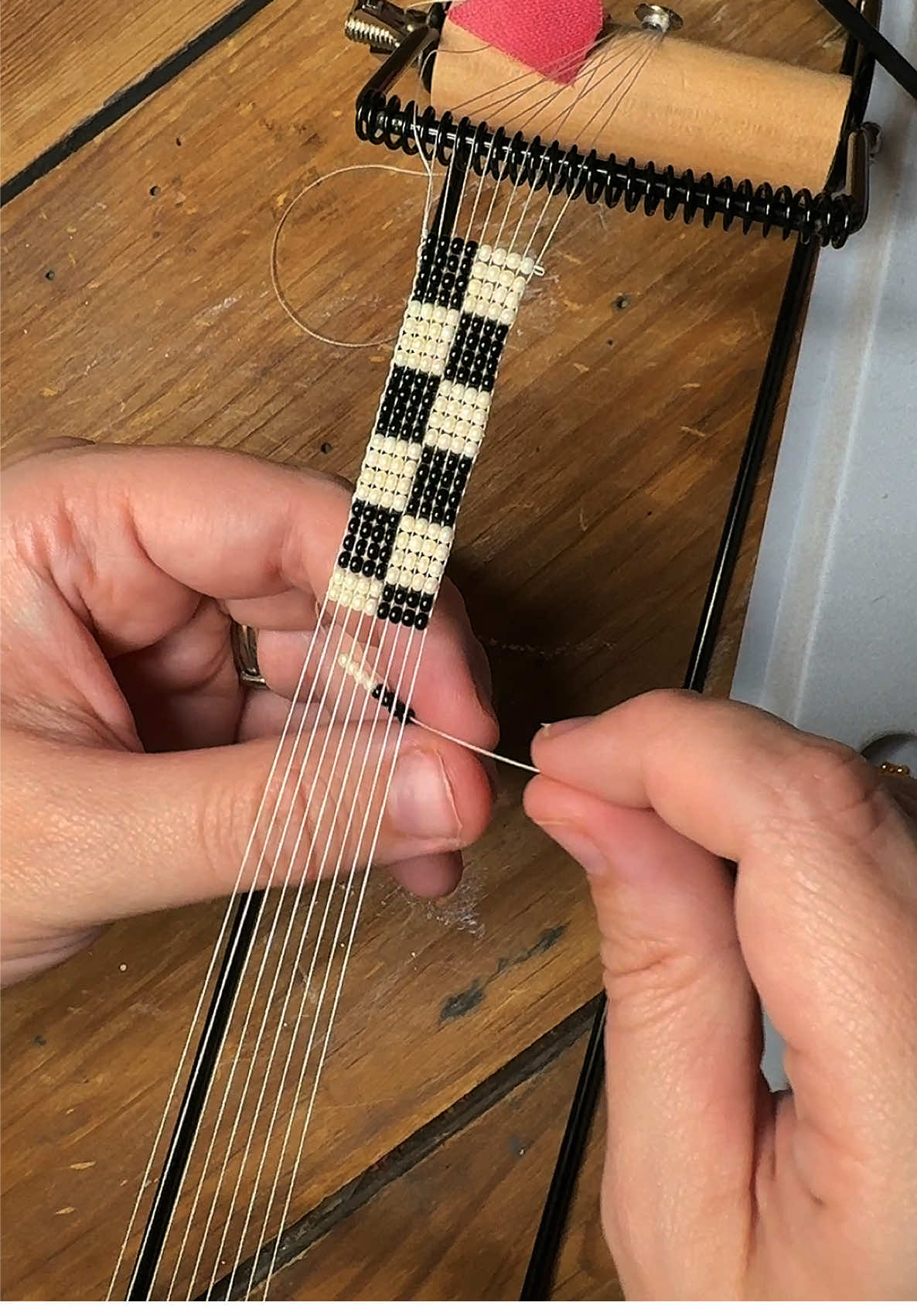 Where are my race fan girlies at?? Make a checkered beaded bracelet on the loom with me! 🏁🩷 #tiktoker #crafting #craft #bracelet #braceletmaking #jewelry #jewelrymaking #checkered #craftingtiktok #beading #beadingloom #loom #indycar #f1 #nascar 