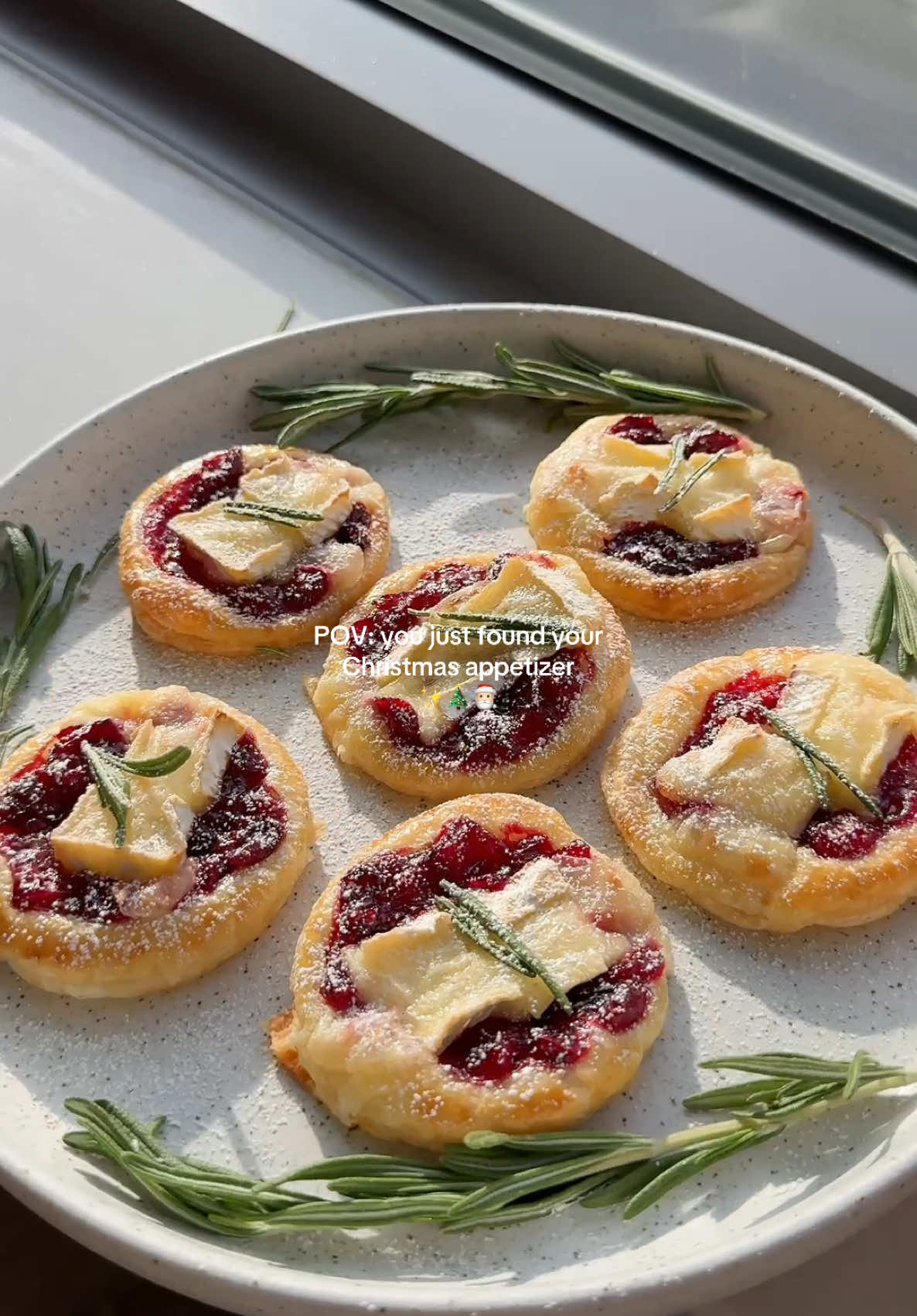 POV: you just found your Christmas holiday appetizer✨🎄🎅🏻 Ingredients:  • 1 sheet of puff pastry, thawed @pepperidgefarm  • 1 wheel Brie cheese, cut into small cubes  • 1 bag of cranberries  • Juice of 1/2 lemon  • 1/4 cup water  • 1/4 cup maple syrup  • 1 egg, for egg wash  • Powdered sugar, for garnish  • Rosemary leaves, for garnish  Instructions:  1. Combine the fresh cranberries, water, lemon juice and maple syrup in a saucepan over medium heat. Cook for 10-15 minutes, stirring occasionally, until the cranberries burst and the sauce thickens, feel free to adjust the sweetness if needed.  2. Preheat the oven to 375°F  3. Roll out the puff pastry and using a cup, cut into equal circles, place them into a baking sheet.  4. Brush the edges of the puff pastry with beaten egg for a golden finish.  5. Add a spoonful of homemade cranberry sauce, followed by a cube of Brie cheese into each circle.  6. Bake for 12-15 minutes or until the puff pastry is golden and puffed.  7. Sprinkle powdered sugar, and enjoy!  #holidayappetizers #christmasappetizers #holidayrecipes #minicranberrypies #homemadecranberrysauce #EasyRecipes 