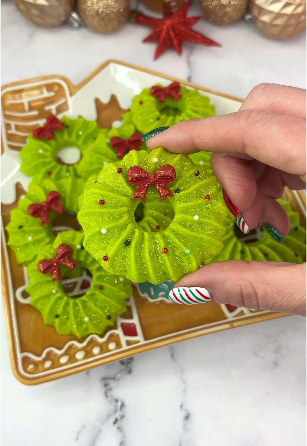 Christmas cookies 🎄❤️ 24 days of Christmas treats 🎅🏼🧁🍪 Recipe🎄 •	120g Unsalted butter (room temp) •     70g Powdered Sugar •	1 large Egg Yolk •	140g All Purpose Flour •	1/4 tsp Salt How to make🎄 1. Whip the butter until light and fluffy. 2. Add powdered sugar and the salt, continue to whip until smooth.  3. Add the egg yolk and mix well. (Add colour gel now if using.) 4. Add in the flour and stir until a soft, pipeable dough forms.  5. If the dough is too thick, add up to 1 tbsp of warm water.  6. Transfer the dough into a piping bag fitted with tip 8B .  7. Pipe the large star shapes onto a baking tray lined with parchment paper. Use the end of a piping tip to make holes in the centres.  8. Pop the tray into the freezer for 20-30 minute before baking.  9. Bake in a preheated oven at 180°C (350°F) for about 15 minutes.  10. Cool completely before decorating. I used a chocolate bow and some edible glitter ✨  #cakedbyrach #christmascountdown #christmasbaking #christmastreats #wreath #EasyRecipe #buttercookie #cutefood #christmasinspo #christmastiktok  