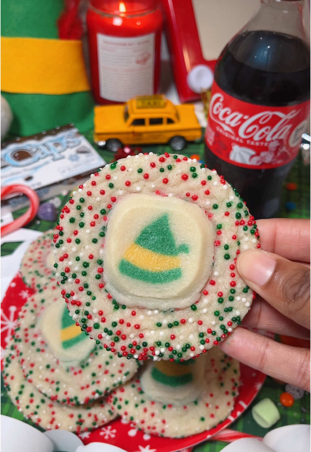 Elf stacked sugar cookies! 🎄 INGREDIENTS:  -Pillsbury sugar cookie dough  -Pillsbury Elf shaped sugar cookie dough  -Christmas nonpareil sprinkles  INSTRUCTIONS:  1. Preheat oven to 350°F and line a baking sheet with parchment paper.  2. Roll sugar cookie dough into a ball and roll the dough around in the sprinkles until fully covered.  3. Place the dough balls onto baking sheet and firmly press down to flatten them slightly.  4. Place an Elf sugar cookie into the center of each flattened dough ball and press down gently.  5. Bake at 350°F for 15 minutes. Let cool slightly on the baking sheet.  6. Enjoy! 🎄  #elf #cookies #elfcookies #christmascookies #christmastreats #christmassnacks #christmasrecipe #holidays #pillsbury @Pillsbury 