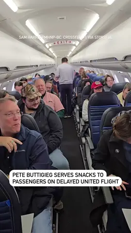 US Transportation Secretary Pete Buttigieg took on the role of flight attendant during a delayed United Airlines flight from Chicago, Illinois, to Traverse City, Michigan, on Saturday, December 14. As United Flight 4400 sat on the Chicago O’Hare tarmac for one hour and 24 minutes, Buttigieg started handing out snacks to his fellow passengers, footage from Sam Harris shows. “It was another frustrating experience with air travel in the US but Secretary Buttigieg did what he could to help the situation in the moment,” Harris told Storyful. Harris said the flight attendant on duty could not leave his post at the front of the plane during fueling operations, and after making multiple announcements offering people to come to the front for drinks and snacks, Buttigieg “spontaneously grabbed the snack basket and began offering snacks to each guest.” “Yes, he made it down the aisle of the entire plane. When the basket was empty, he returned for a second trip to make sure he included all passengers. He smiled and made small talk along the way,” Harris said. “Everyone appreciated the gesture,” according to Harris, who said the flight eventually made it to Traverse City with a one-hour delay. #news #united #unitedairlines #travel #chicago #chicagonews #petebuttigieg