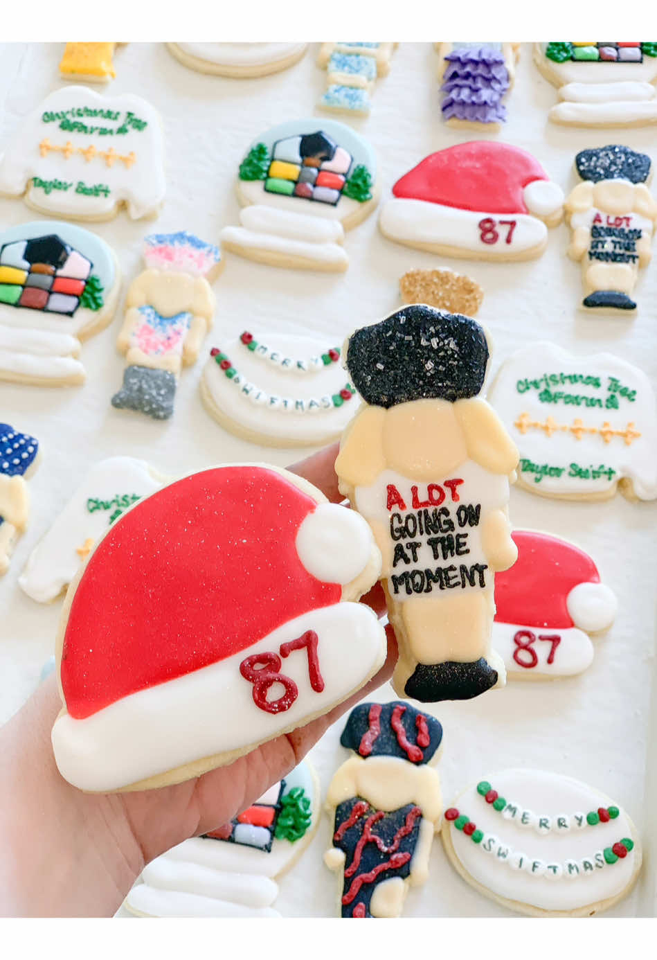 Merry Swiftmas Cookies 🎄🫶🏻 #risecupcakes #merryswiftmas #taylorswift #swiftie #taylorswiftcookies #cookies #cookiedecorating #87 #christmastreefarm #loverhouse #alotgoingonatthemoment #nutcracker 