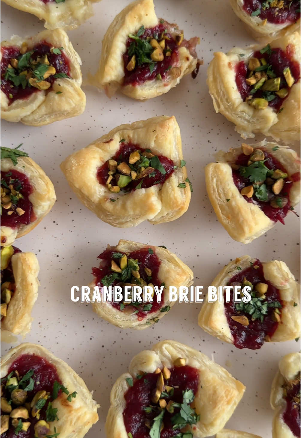 CRANBERRY BRIE BITES If you are looking for an easy and delicious appetizer for the holidays, that is sure to be a crowd pleaser. Make these cranberry brie bites. Made with a homemade cranberry sauce but can also be made with your favorite store bought jams too! What you will need: Avocado oil spray 2 gluten free puff pastry sheets (you can use regular puff pastry too) Homemade cranberry sauce (see below) 7 oz Brie cut into 24 bite size pieces Fresh cilantro Chopped roasted pistachios Cranberry Sauce: 1 cup fresh organic cranberries 2 Tbsp coconut aminos 2 Tbsp balsamic vinegar 1 Tbsp spicy brown mustard 1 tsp garlic powder 1/2 tsp ginger powder 1/4 cup honey or maple syrup Instructions: 1. Prepare your cranberry sauce by mixing everything in a pot on medium heat until the cranberries burst and the sauce thickens. Once done remove from heat and let rest for 10 minutes. 2. Cut your defrosted puff pastry sheets into 24 squares 3. Spray your mini muffin tin with avocado oil spray 4. Add puff pastry squares to greased muffin tin 5. Cut up your brie into 24 bite size cubes and add to center of puff pastry 6. Top with desired amount of cranberry sauce 7. Bake for 12-15 minutes or until golden brown 8. Top with chopped pistachios, fresh cilantro, and enjoy . . #appetizerideas #appetizerrecipe #holidayappetizers #christmasappetizers #easyappetizers #cranberrybriebites #puffpastryrecipes #briecheese #christmaspartyfood