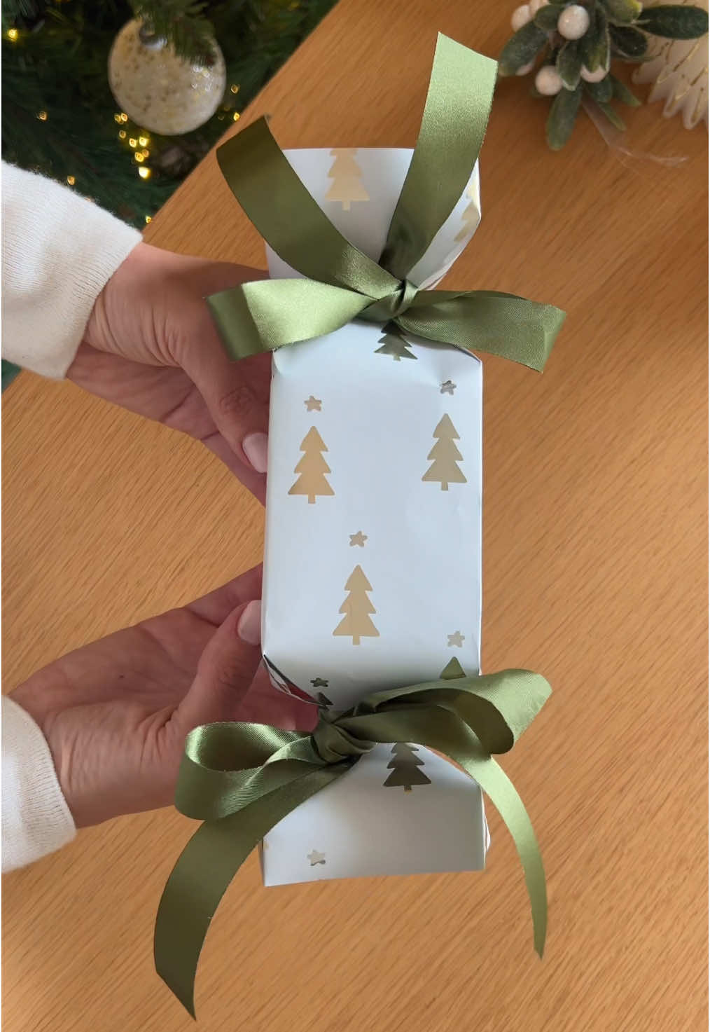 🎁 Easy hack for wrapping oddly shaped gifts without a bag! 1️⃣ Measure paper around the gift and tape to hold 2️⃣ Fold the paper in half 3️⃣ Fold the sides inward, cutting corners diagonally 4️⃣ Place the gift inside 5️⃣ Tie the sides with ribbon  Who’s ready to try this? 🎀 #giftwrapping #hacks #christmas #christmastiktok 