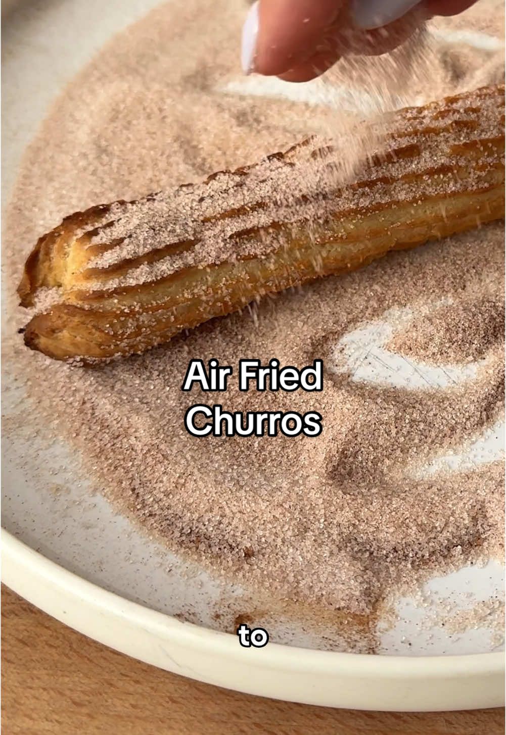 These never get old 🥹 air fried churros, so easy & so delish!  Ingredients (for 4 churros) -1/2 cup water  -2 1/2 tbsp cold butter, cubed -3 tbsp granulated sugar, divided  -large pinch salt -1/2 cup flour -1/2 tsp vanilla extract  -1 egg  -cooking spray  -1/2 tsp cinnamon  Directions: -In a medium pot over medium heat, add in the water, butter, 1 tbsp sugar, and salt. Bring to a boil. Reduce the heat to medium low, and add in the flour. Use a spatula to stir in the flour in until it’s all incorporated. -Set the mixture into a mixing bowl and allow to cool slightly (about 5 minutes). Add in the vanilla extract and egg, and use an electric mixer or stand mixer to mix. Stop once the dough is evenly incorporated. -Line a baking sheet with parchment and spray it with cooking spray. Place the dough into a piping bag with a large star tip. Squeeze out the churros, about 5 inches long each. Use scissors to cut the dough. Place the churros into the fridge for an hour.  -Preheat air fryer to 350 and spray the basket with cooking spray. Spray the churros with cooking spray and place them onto the basket. Cook for 10-12 minutes, until golden brown. -On a plate, combine the remaining 2 tbsp sugar and cinnamon. Stir to mix, then roll the cooked churros in the sugar mixture. Serve churros and enjoy!  #churros #airfryerrecipe #airfryer #churrorecipe #EasyRecipe #sweettooth #easyentertaining #holidayseason 