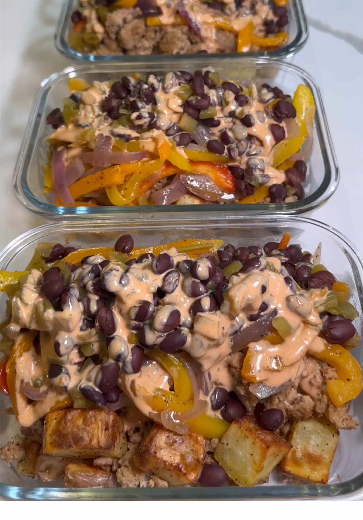 Turkey and Roasted Potato Taco Bowls 🦃🥔🌶️ Sharing a quick and easy meal prep recipe for you all to enjoy! This recipe uses bold taco flavors and allows you to layer various components for a flavorful and filling bowl. The creamy chipotle sauce adds the perfect touch to bring it all together! Enjoy! Servings: 4 Serving Size: 130g potatoes, 150g turkey (double serving), 100g black beans, 130g peppers and onions, 2 tbs chipotle sauce Macros: 781 cal, 52g P, 57g C, 39g F *To reduce the calories, divide the food into 6 smaller servings or measure a single serving (75g) of turkey.* Seasoned Ground Turkey 🦃 Ingredients: -2 lbs ground turkey -1 tbs olive oil -2 tbs taco seasoning of your choice Instructions: -heat large pan to high heat and add oil -brown ground turkey and add spices; mix well -cook for an additional 1-2 minutes Roasted Potatoes 🥔 Ingredients: -4 lbs yellow potatoes, diced into 1/2” cubes -2 tbs olive oil -2 tsp salt -2 tsp pepper Instructions: -add diced potatoes into large bowl with oil and spices; mix well -air fry at 400F for 20 minutes until crispy Peppers and Onions 🫑 -2 bell peppers, cut into thin 1/4” strips -1 red onion, cut into 1/4” slices -1 tbs oil -1 tsp salt -1 tsp pepper Instructions: -add peppers and onions into a large bowl with oil and spices; mix well -heat large pan to high heat and add in the peppers and onions -sauté for 6-8 minutes until tender Seasoned Black Beans 🫘 Ingredients: -1 can unsalted black beans -1 small can of diced green chilis -8 oz. water -1 tbs taco seasoning -1 tsp salt -1 tsp pepper Instructions: -add ingredients into a small pot and mix well -cover and simmer on low for 5-10 min until tender Creamy Chipotle Sauce 🌶️ Ingredients: -1/4 cup mayo or Greek yogurt -2 tbs chipotle sauce -1 tsp taco seasoning -juice of half a lime Instructions: -add above ingredients into a small bowl and whisk together well #mealprep #chipotle #turkey #EasyRecipes #potatoes #taco #tacobowl #mealplan #mealprepping #quickrecipes #lunch #lunchideas #quickmeals #macros #cleaneating #healthyfood #highprotein #easymeals #homechef #food #Foodie #cooking