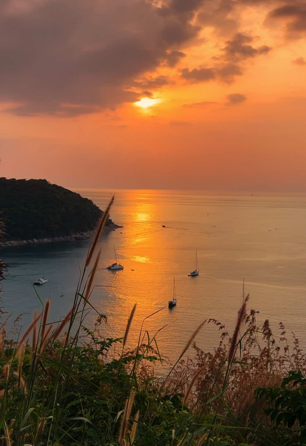 Windmill Viewpoint offers breathtaking views of the Andaman Sea and a peaceful atmosphere. Nestled in Rawai, this stunning location is perfect for soaking in the beauty of a Phuket sunset. #windmillviewpointphuket #naiharnbeach #rawai #phuket #fyp #foryou 