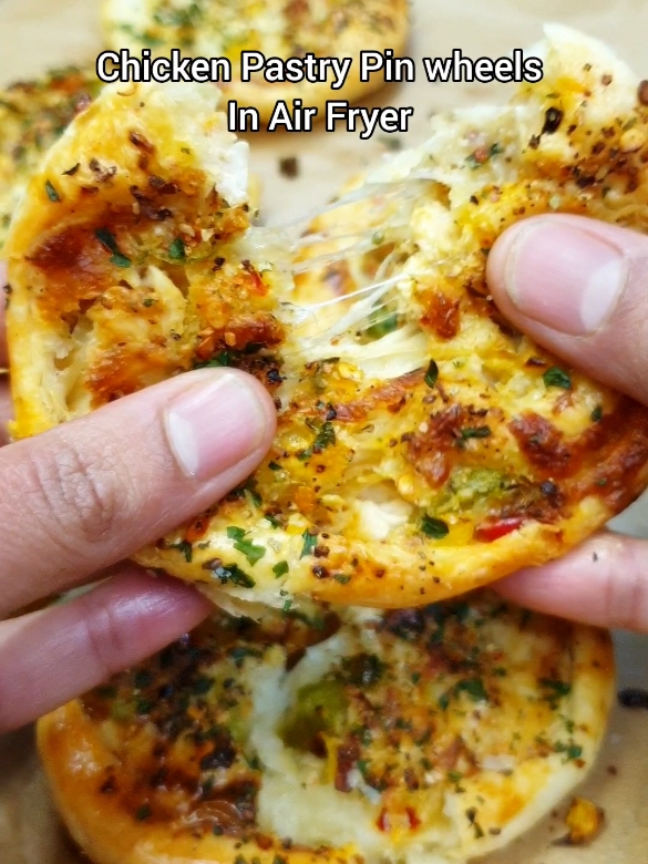 Chicken Pastry Pin Wheels In Air Fryer. Perfect appetiser for holiday season and yes this is an air fryer 😌 Ingredients and steps: 2 chicken breast 1 tsp salt 1 tsp paprika 1 tsp black pepper  1 tsp onion granules  1 tsp garlic granules  1 tsp dried parsley  2 tbsp oil Coat the chicken  Air fry at 180ºC for 25-30 minutes.Flipping after 20 minutes. Chop the cooked chicken. Transfer to a bowl. Add 1 chopped onion  Chopped peppers (1 cup) 1/2 tsp salt 1/2 tsp black pepper 1/2 tsp red chilli flakes  1 tsp Italian seasoning  Half cup mayonnaise  Half cup mozzarella cheese  Mix everything. Take ready-made puff pastry sheet Spread the filling on it.Roll the pastry. Cut in equal size pieces. Press them with your hand Place them in your air fryer tray or basket. Coat with egg wash(1egg yolk+1/4 cup milk). Sprinkle some dried parsley  and any seasoning of your choice. I used peri peri.Preheat your air fryer for 10 minutes at it's  highest temperature. I didn't preheat because my air fryer has bottom rods as well that cook everything without the need of flipping 😁 Air fry at 190ºC for 15 minutes and enjoy! #airfryer #airfryerrecipes #appetizers #appetizer #snack #puffpastry #chicken 