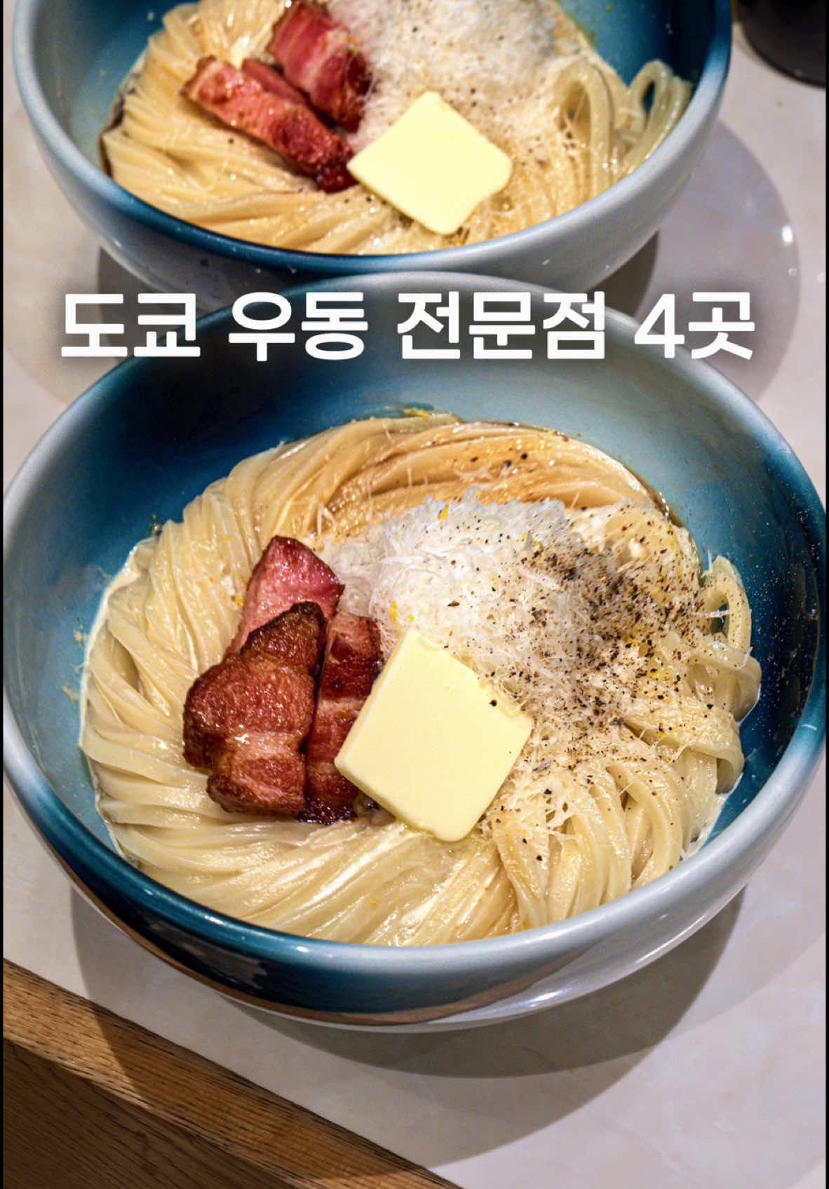 장인이 운영하는 도쿄 우동집 4곳 떡처럼 쫄깃하지만 국물과는 또 기막히게 어우러지는 장인의 우동집 4곳을 소개합니다. 1. 까르보나라 우동  일본과 이탈리아를 한 그릇에 합친 퓨전 우동 2. 명란버터 우동 주문 즉시 반죽해 갓 삶아낸 신선한 우동  3. 블랙 우동  45년 노포의 된장 베이스 검은 우동 4. 히모카와 넓적우동  얼굴 크기만한 면발의 넓적 우동  Introducing four artisan udon shops in Tokyo where the noodles are as chewy as mochi yet perfectly complement the broth. 1. Carbonara Udon A fusion of Japan and Italy in one bowl. 2. Mentaiko Butter Udon  Freshly made-to-order udon, kneaded and cooked on the spot. 3. Black Udon A miso-based black udon from a 45-year-old shop. 4. Himokawa Flat Udon Flat noodles as wide as your face. #도쿄맛집 #우동 #udon #tokyofood #tokyogourmet 
