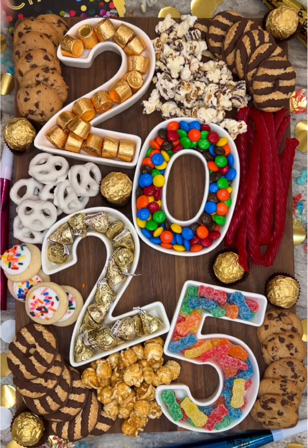 Cheers to hoping 2025 is just as sweet as this board is! 🤩😅🤞🍬 We're almost to the new year, friends, and what better way to ring it in than with a fun New Year’s Eve Dessert Board, topped with everyone’s favorite sweet treats! 🍿🍪🥳  What we’re adding to our board this year: 🎉 Rolos 🎉 M&M’s 🎉 Hershey’s Kisses 🎉 Sour Patch Kids 🎉 Fudge Stripe Cookies 🎉 Chocolate Chip Cookies 🎉 Twizzlers 🎉 Yogurt Covered Pretzels 🎉 Mini Frosted Sugar Cookies 🎉 Chocolate Drizzled Popcorn 🎉 Caramel Popcorn 🎉 Ferrero Rocher Details on my blog and LTK! #dessertboard #snackboard #popcorn #cookies #candyboard #sweettreat #newyears #newyearseve #newyearsideas #happynewyear #newyearseveparty 