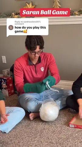Replying to @sandravalero00 this is how the saran ball game works. Someone starts with the ball with  mittens on and starts unrolling it, that person beside them is rolling dice in a box once they roll doubles it’s their turn to try to unwrap the ball. As prizes fall out of the ball you get to keep them.  😊it is such a fun family holiday game!  The kids love it!  #familychristmas #holidaygames #christmasgames #saranball #christmasfamilyfun #saranwrapgame #saranwrapball