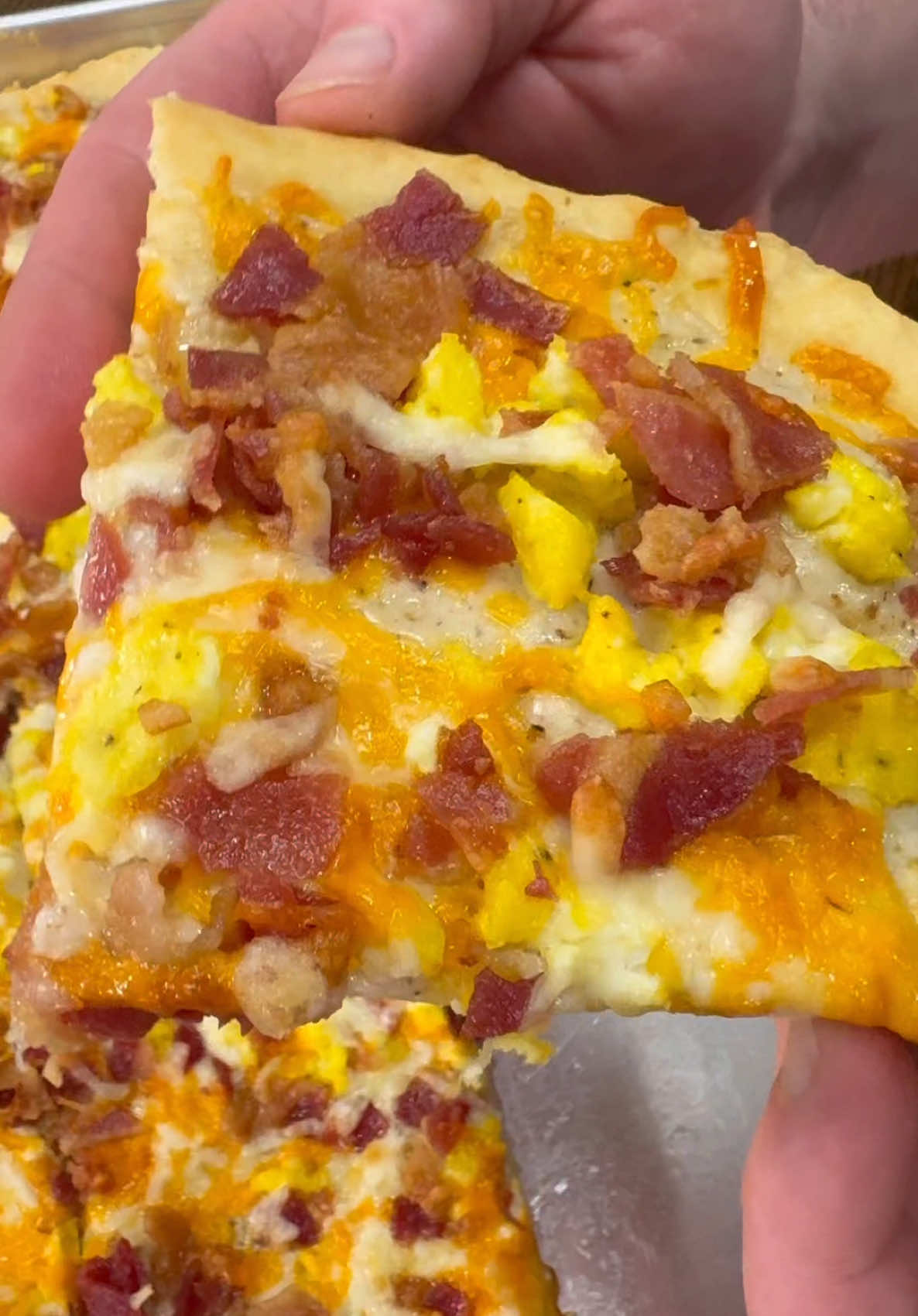 Sheet Pan Breakfast Pizza is easy to make at home and freezes/reheats well making it an awesome breakfast prep!  INGREDIENTS  2 packages of Pizza Crust + ingredients needed to make pizza crust  Gravy (3 tbsp butter, 3 tbsp flour, and 2 cups of milk)  8-10 pieces of bacon  4 eggs scrambled  Shredded cheddar cheese Shredded Mozzarella cheese  Salt and pepper  INSTRUCTIONS  Cook bacon in the oven at 400 degrees F on a sheet pan lined with parchment paper. Bake for 20-25 minutes.  Mix pizza crust following the directions on the package. Spread the pizza crust out over a large sheet pan. Poke holes in the pizza crust and prebake following the directions on the package.  Scramble at least 4 eggs, season with salt and pepper, and set aside.  Make the gravy by melting 3 tbsp of butter in a large skillet over medium high heat. Add 3 tbsp of flour and stir together. Let flour and butter cook for one minute. Add 2 cups of milk and stir continuously until gravy reaches your desired consistency seasoning with salt and pepper. After prebaking the pizza crust, spread some of the gravy over the top. Top with shredded cheese, eggs, and chopped bacon.  Bake at 475 degrees F for about 10 minutes. Enjoy!  I always put leftovers in the freezer and reheat in the air fryer at 400 degrees for 5-7 minutes.  #breakfastpizza #breakfastprep #EasyRecipes #easybreakfast 