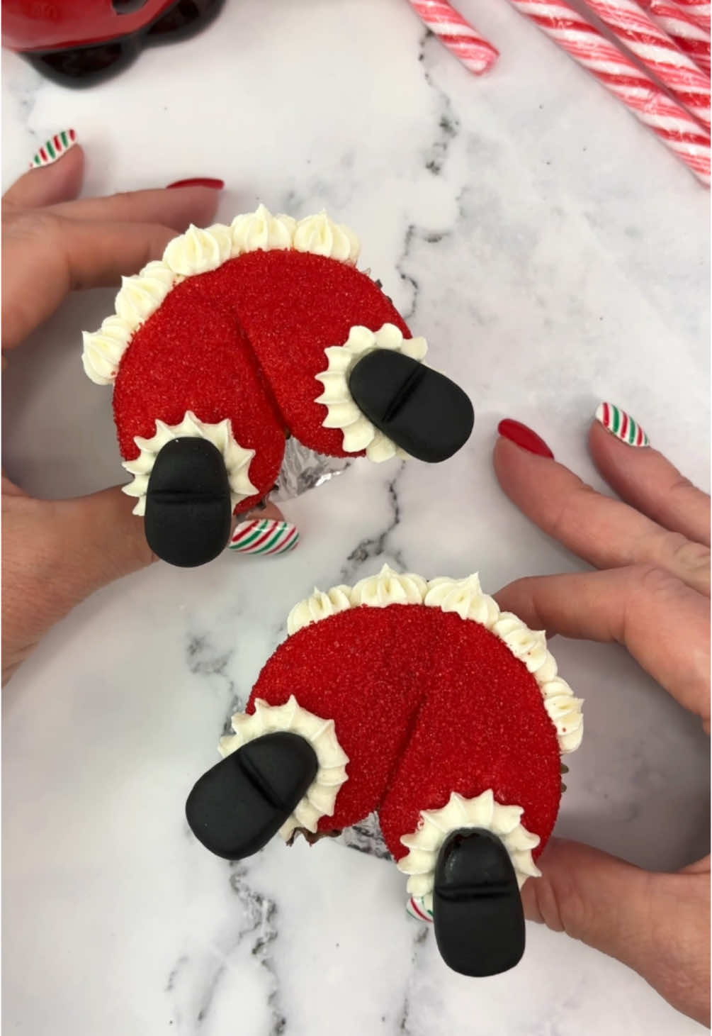 Santa butts 🎅🏼😝 Day 22 of 24 days of Christmas treats 🎅🏼🧁🍪  Christmas crack 😜🎅🏼 🎅🏼 Fill your liners half full. 🎅🏼 Use foil balls to shape your liners. 🎅🏼 Bake and cool. 🎅🏼 Use  large round tip to pipe red buttercream in the shape of Santa’s butt 😝 🎅🏼 Press into red sanding sugar.  🎅🏼 Use tip 32 to pipe a white buttercream trim across the top and two larger stars where the shoes will sit. 🎅🏼 I made the shoes using black fondant. #cupcake #christmasbaking #santa #cakeart #bakinginspo #cakedbyrach #christmastreats #christmascountdown #christmastreats #christmastiktok 